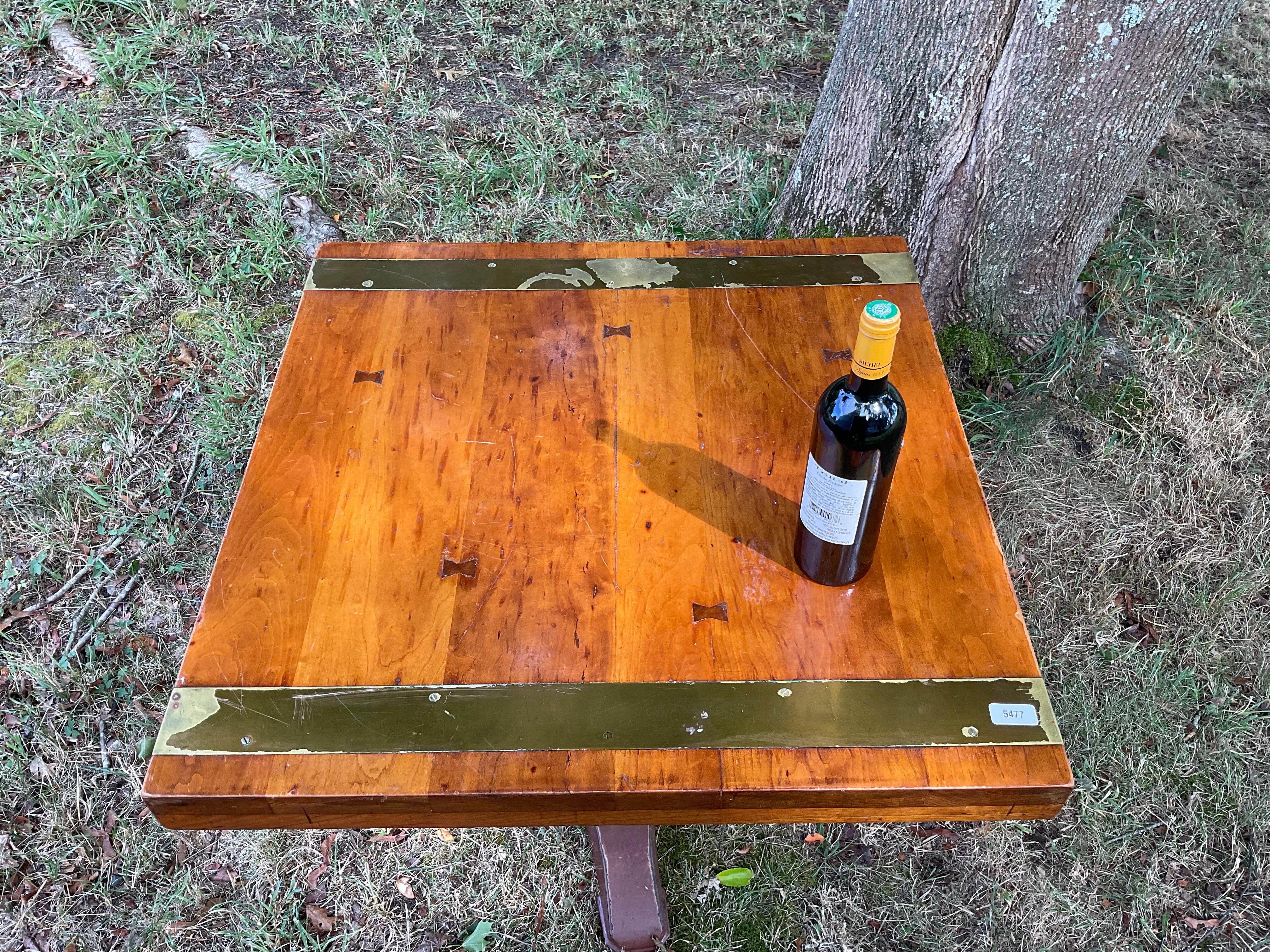 Brass bound dining table from Antnony's Pier 4 Restaurant in Boston. Thick laminated wood top with bow tie fasteners. Pedestal base from the 