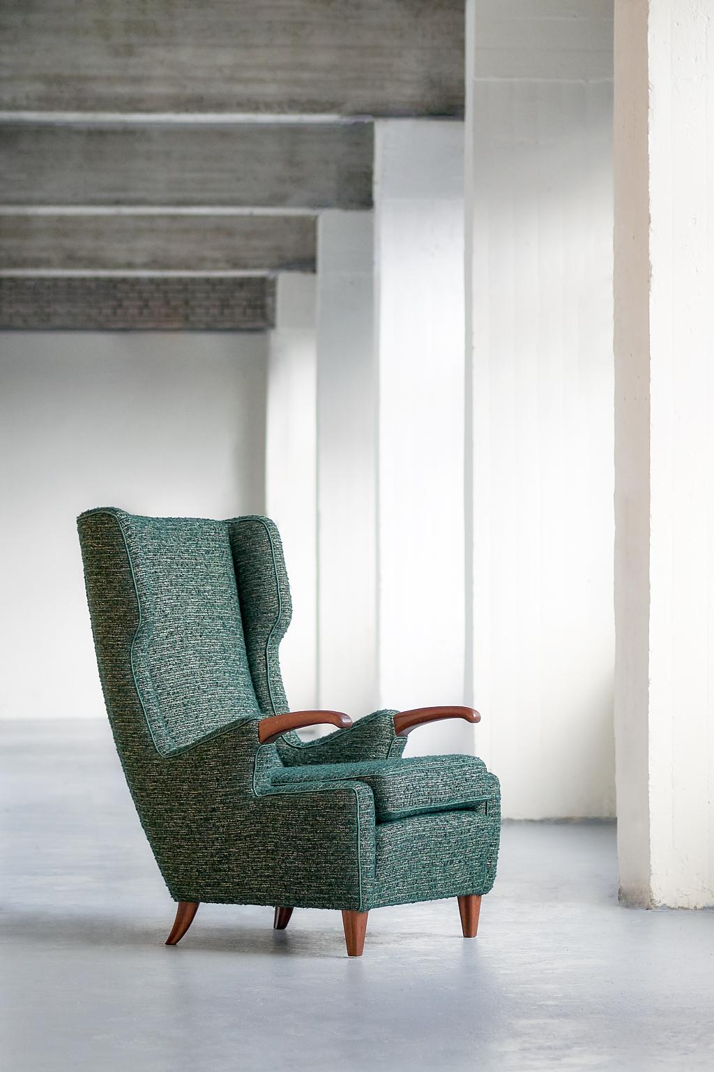 This rare armchair was designed by Pier Luigi Colli and manufactured by his Turin workshop Colli in 1947. The sophisticated design was numbered model 505. The striking curved armrests and legs are in solid walnut. The chair has been fully