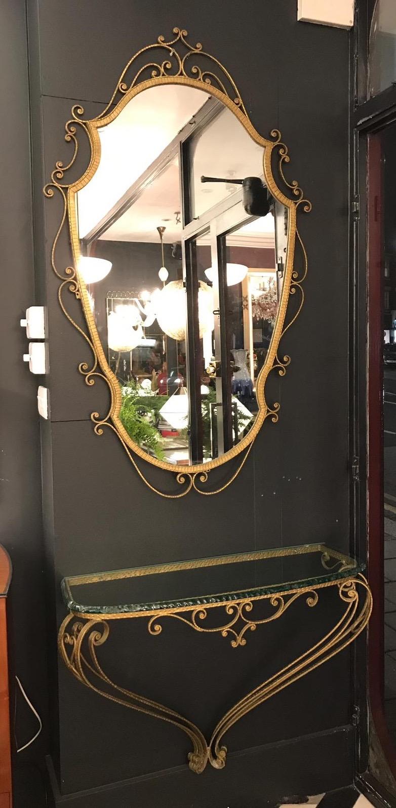 Matching mirror and console table by Pier Luigi colli made from hammered wrought iron featuring a gilt finish - 2cm thick glass top att. to Fontana Arte.  

The mirror measurements are 52 H x 30 W inches.
The console table is 25 H x 33 W inches.