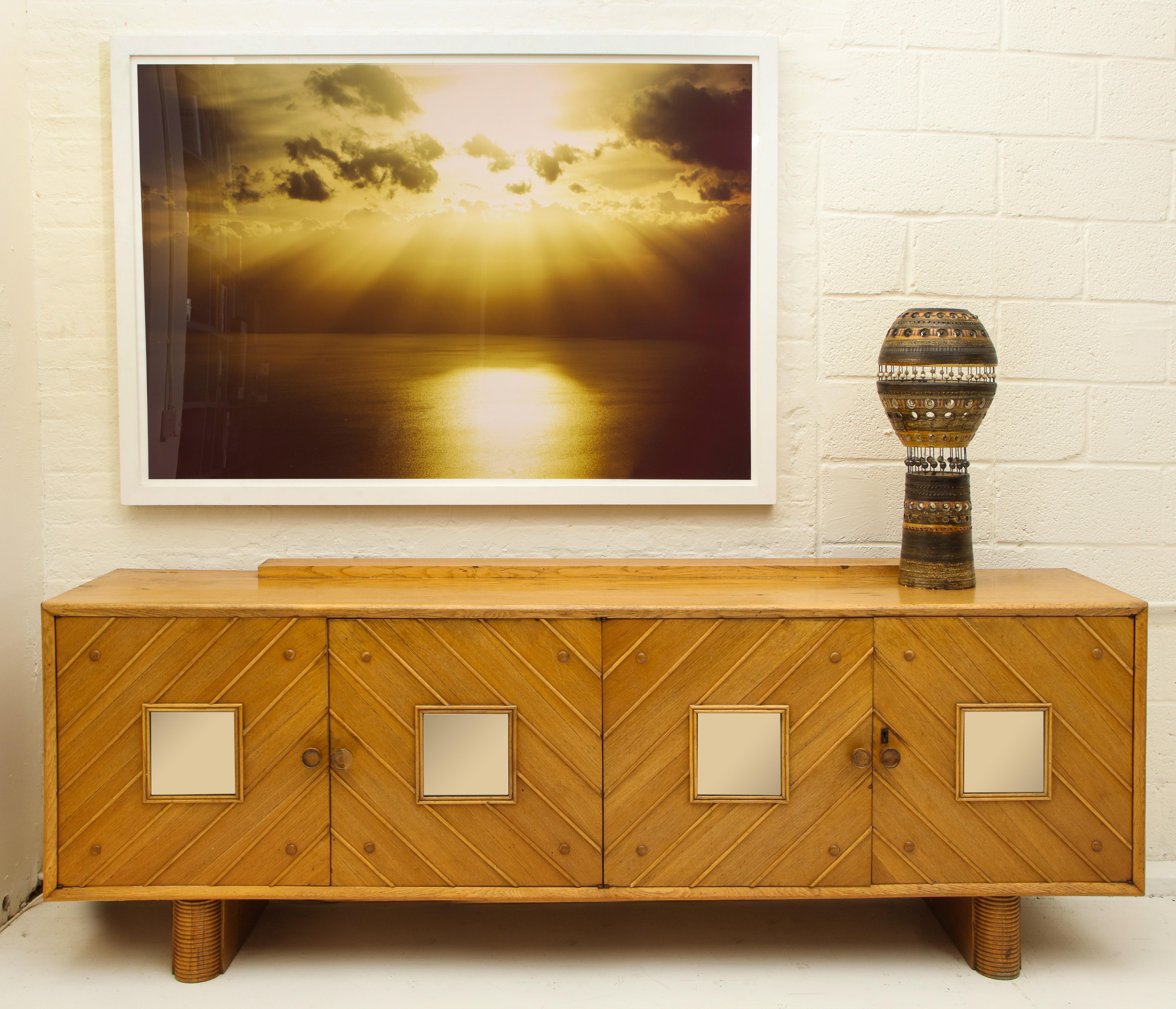 Pier luigi Colli oak sideboard, Mid-Century Modern, Italy, 1950s

Beautiful oak sideboard. The oak has lovely patina throughout the piece. 
It is a large-scale sideboard with four doors and architectural details throughout.
Amazing oak grain
