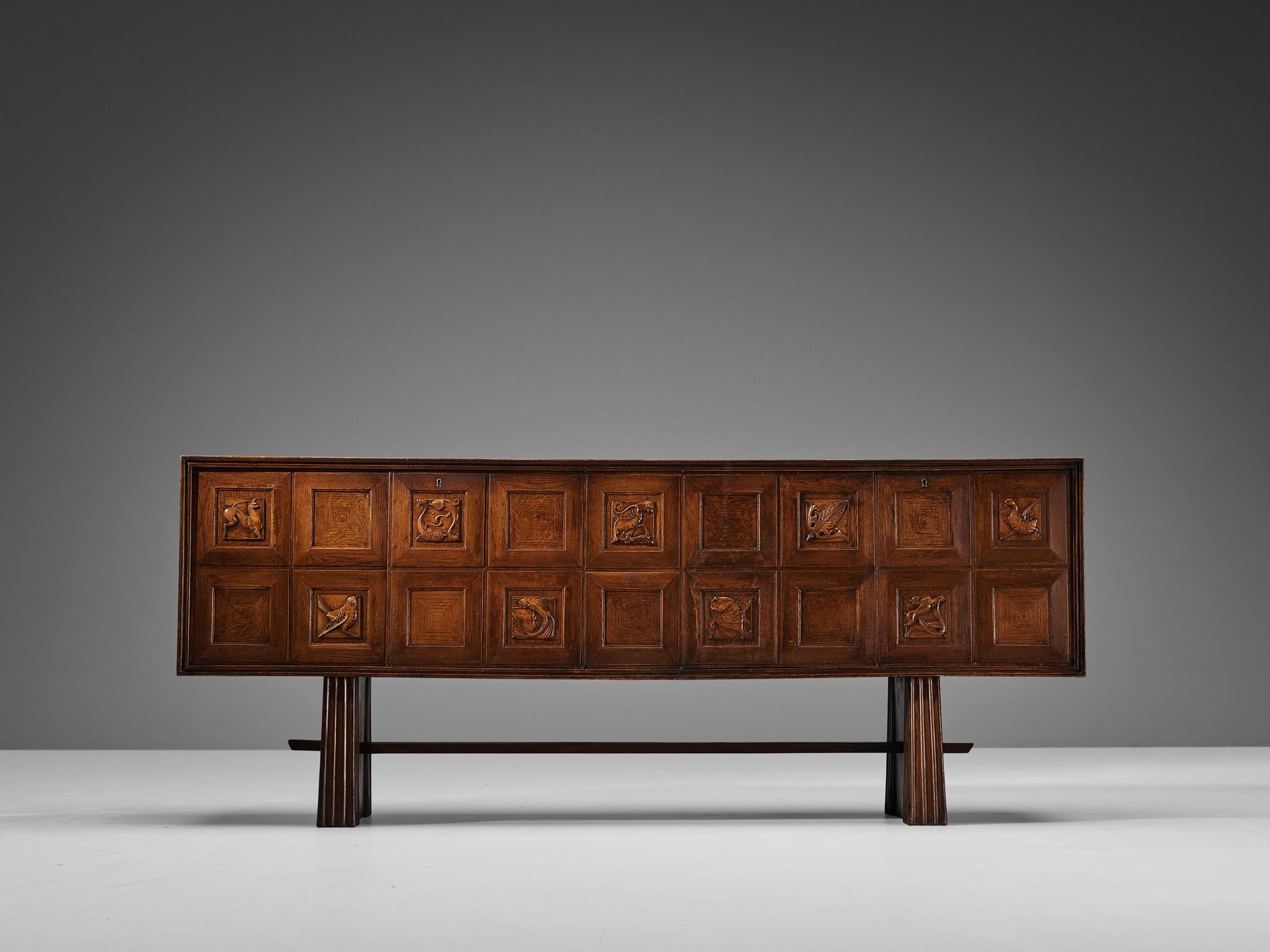 Pier Luigi Colli sideboard, oak, Italy, 1940s

This elegant and beautifully made sideboard is designed by Italian Pier Luigi Colli. The front of this piece has eighteen panels, that are decorated through amazing carving of the wood used. They are
