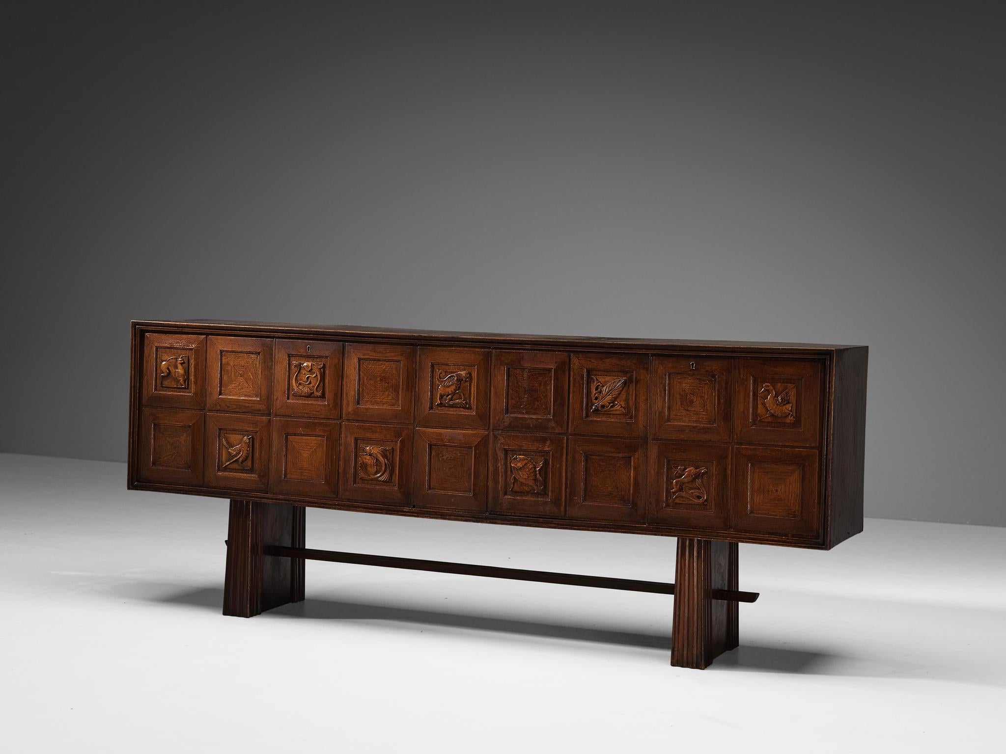 Pier Luigi Colli, sideboard, oak, Italy, 1940s

This exquisite credenza, a creation of the Italian designer Pier Luigi Colli, embodies both elegance and exceptional craftsmanship. The front facade of this masterpiece comprises eighteen panels, each