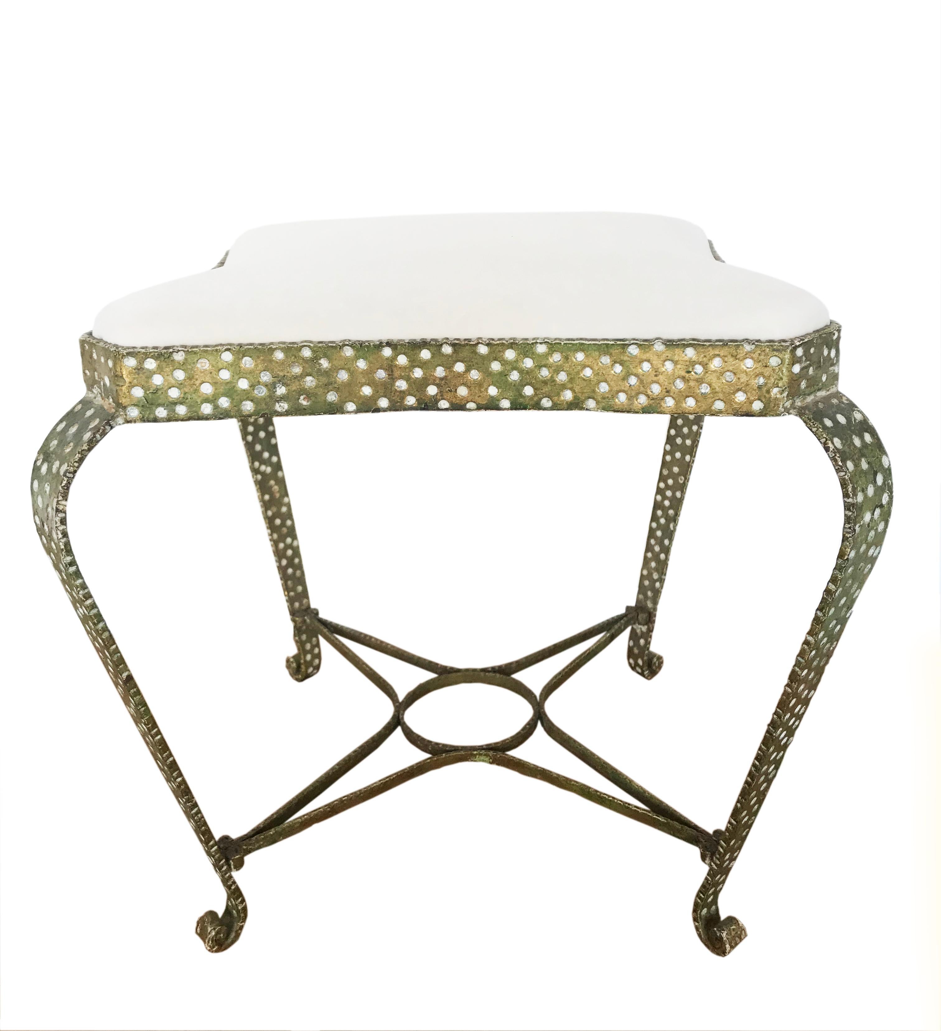 Highly desirable wrought metal footstools with gold overlay, hammered dotted design. Upholstered in cream velvet. Italian, circa 1950s.
Designed by Pier Luigi Colli.

Pier Luigi Colli (1895-1968) studied at the Paris École des Arts Décoratifs and