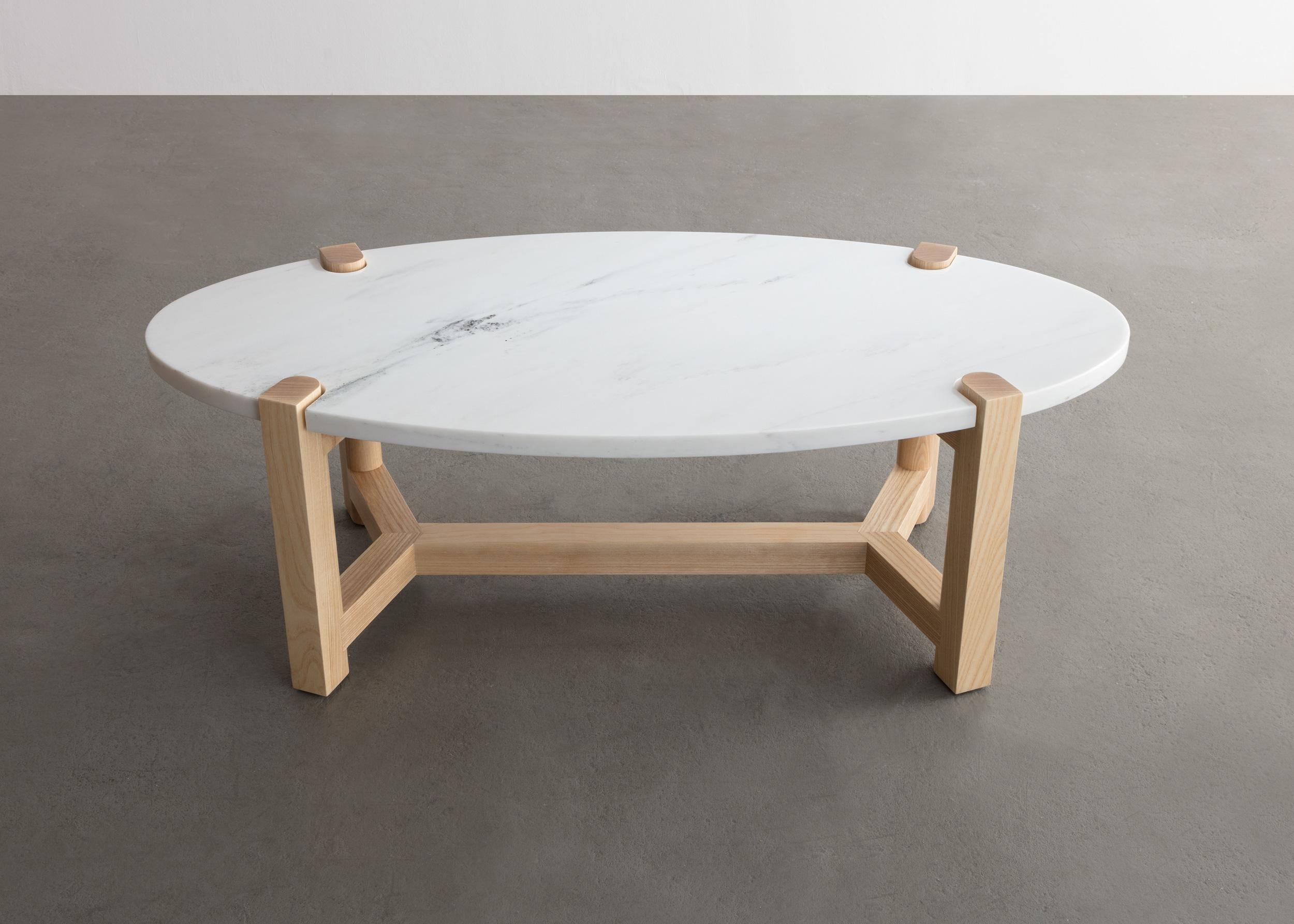 Here details and connections become the focus at the intersection of surface and structure.

Frame shown in ash and also available in cherry, maple, or walnut. 
Top shown in white Danby marble and also available in custom stone and material upon