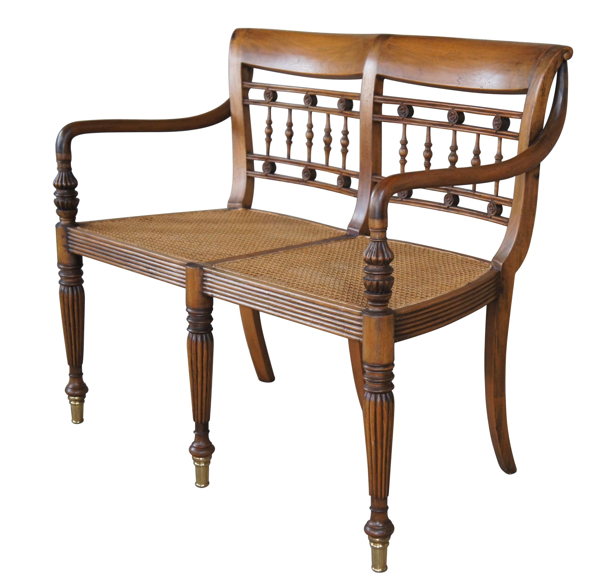 Vintage Pierce Martin British Colonial Regency Plantation bench.  Made of mahogany featuring caned seat with piereced spindel and floral medallion back support, sloped arms, caned seats, and fluted tapered legs with brass capped