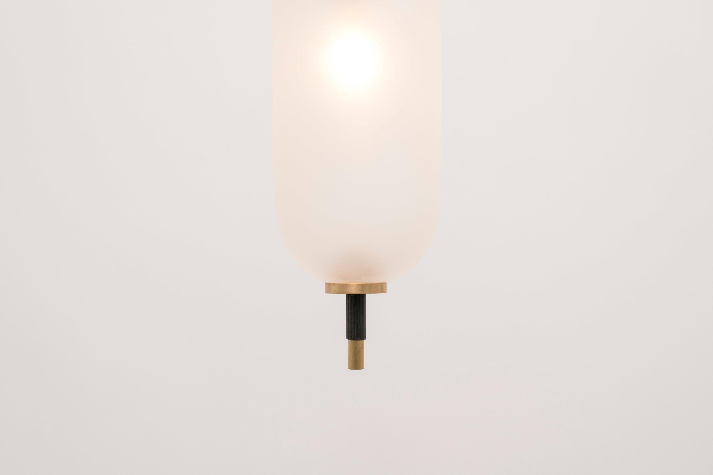 A jewel-like pendant composed of a brass stem with sandblasted glass orbs that seem to pierce through them. The bulb inside the glass orb emits a defused glow from the center of its core. Stem height customized for each application.

UL listed.