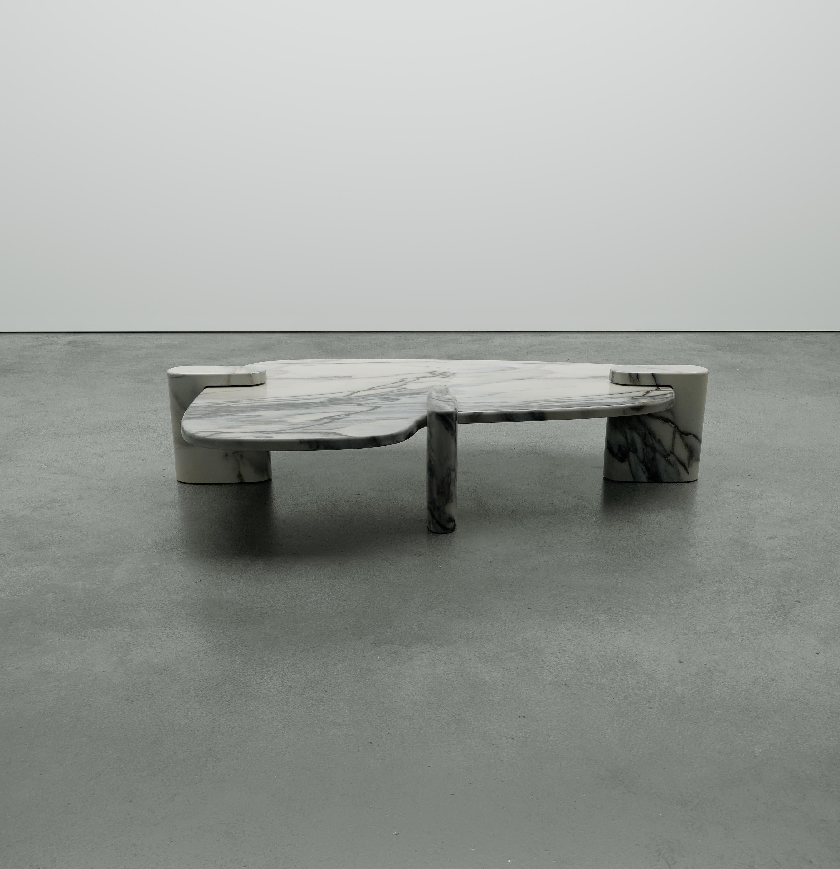 Inspired by biomorphic design, the table uses asymmetrical forms made from Pele de Tigre marble.
