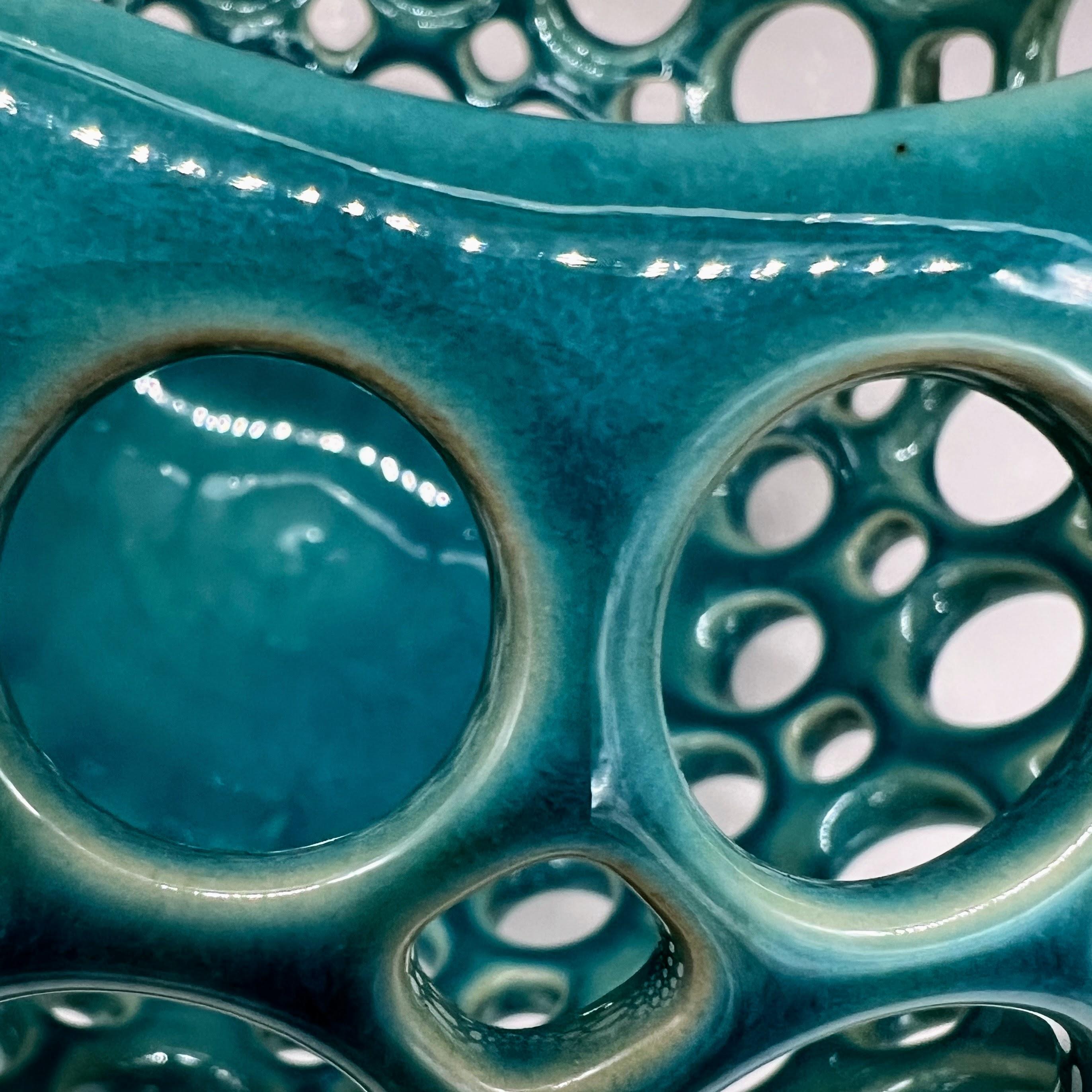This piece is wheel thrown and hand pierced. When the piece is still wet, small holes are mapped out and pierced. Once the orb is bone dry, each hole is painstakingly enlarged. A turquoise crackle glaze is then applied and fired. Perfect as an