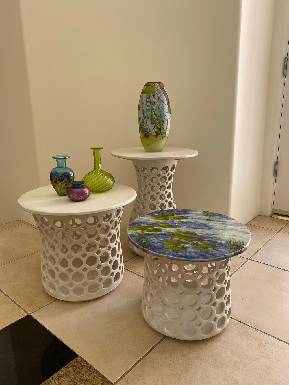 Inspired by Asian and impressionist painting, this pierced ceramic end table is a collaboration between ceramicist Lynne Meade and tile maker Sue Barry. Lynne's table base is wheel thrown and hand pierced stoneware with a satin glaze. Small holes