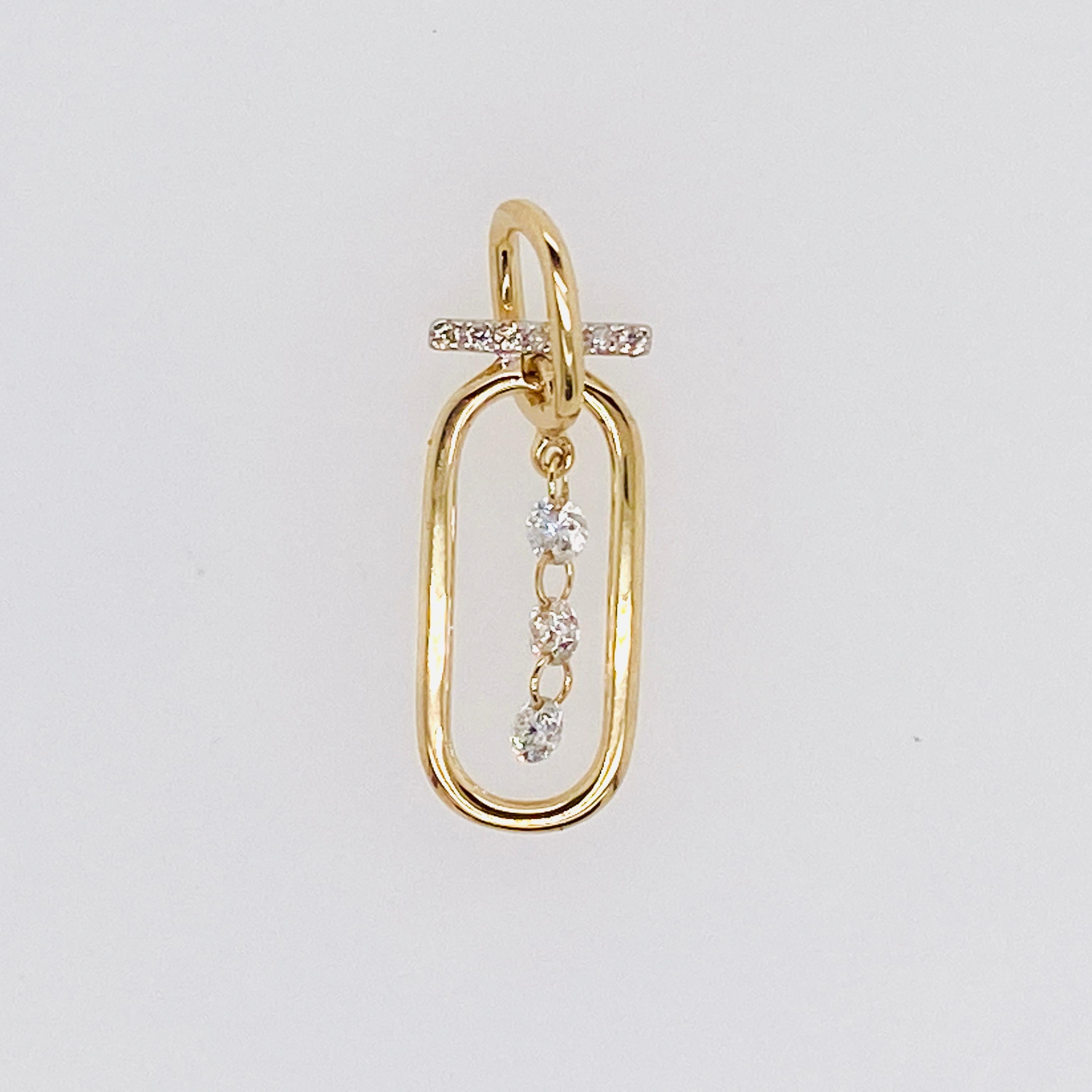 Three diamonds dance inside this bright paperclip pendant frame that measures ~3/4 inch long and 1/2 inch wide. The diamonds are linked together through pierced edges to make a nearly invisible connection as they sway together in their frame. The