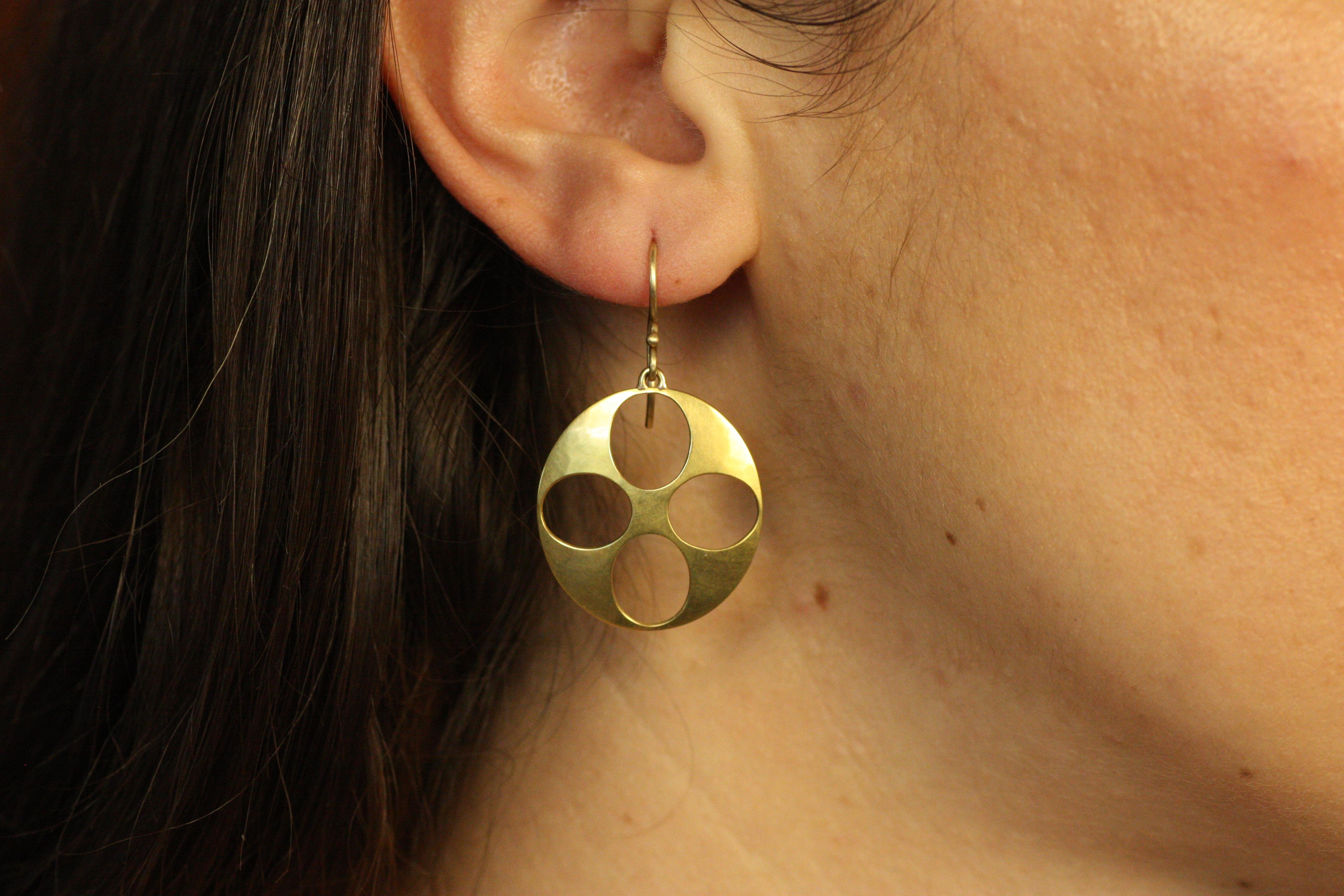 These 22K Pierced Disc Earrings offer a minimalist yet bold design with an open circle motif, handcrafted from rich yellow gold. Their lightweight, airy design is perfect for those seeking simple elegance with a modern twist. Wear casually or dress