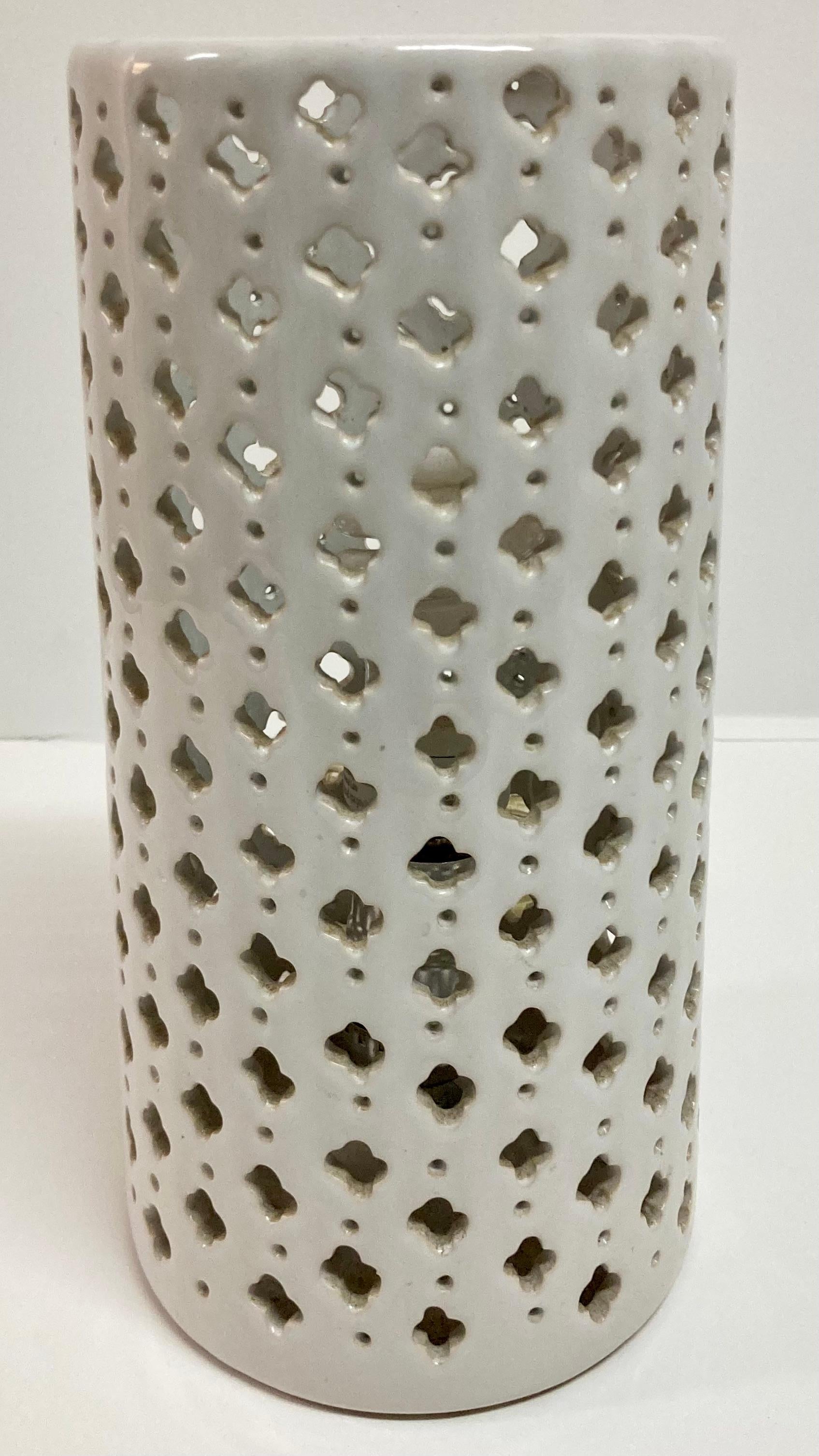 Pierced pattern ceramic cylinder uplight. Add some dram to your home with creative lighting.