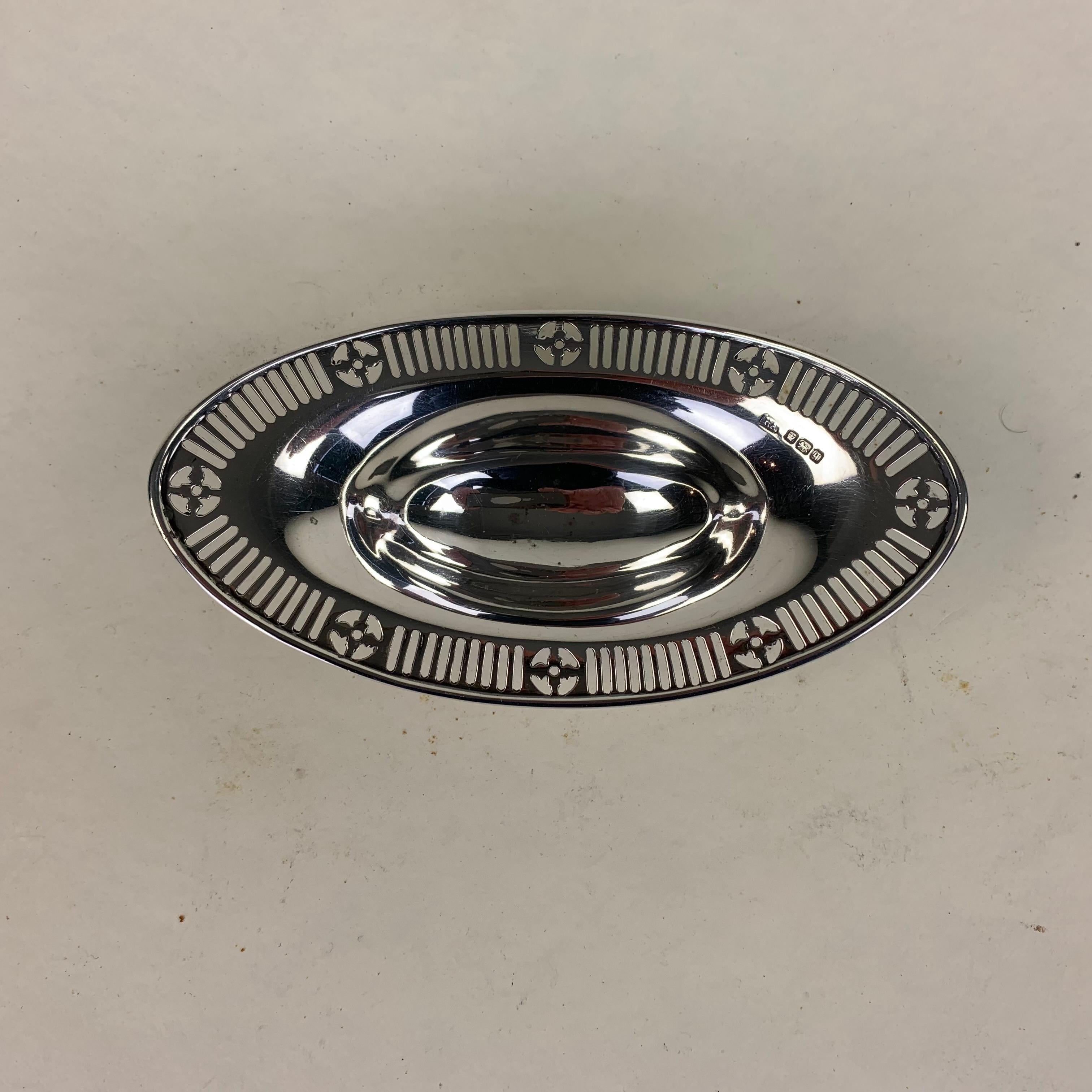 An attractive oval sweetmeat 125 with pierced border and standing on scrolled paw feet. Made by Atkin Brothers of Sheffield in 1908 with retailers mark of Stuart Dawson of Regent Street and Hatton Garden, London, 1908. 67 grams.