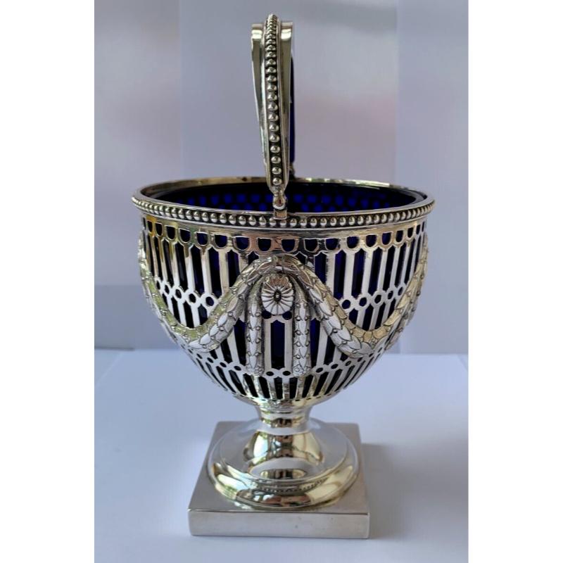 In good vintage condition, this is an elegant George V pierced bowl stands on a pedestal base and has pierced floral decoration and beading around the top of the body and across the top of the handle. Probably originally intended as a sugar bowl,