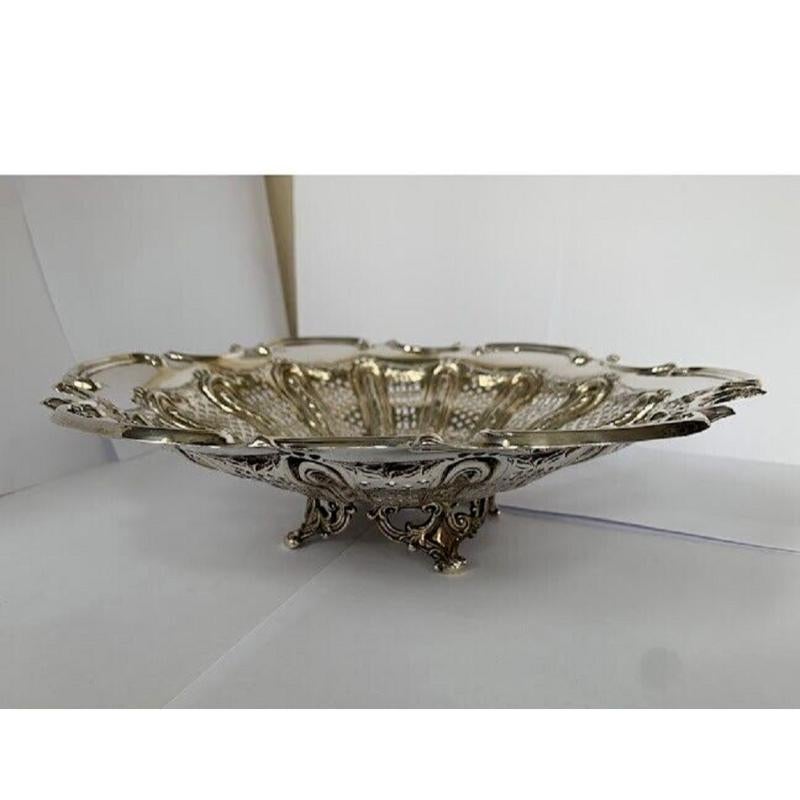 Large Pierced Victorian Sterling Silver Bread Basket or Fruit Bowl. This is in very good vintage condition. It has beautiful openwork and a lovely embossed border. It stands on four delicate feet. It could be used for many things or looks lovely