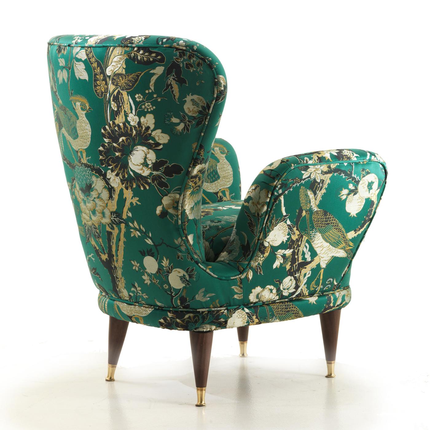 A superb object of functional decor, this armchair will be a stunning statement piece in a modern entryway, classic living room, or eclectic study. Its elegant silhouette is made of wood and is entirely upholstered for a comfortable seating