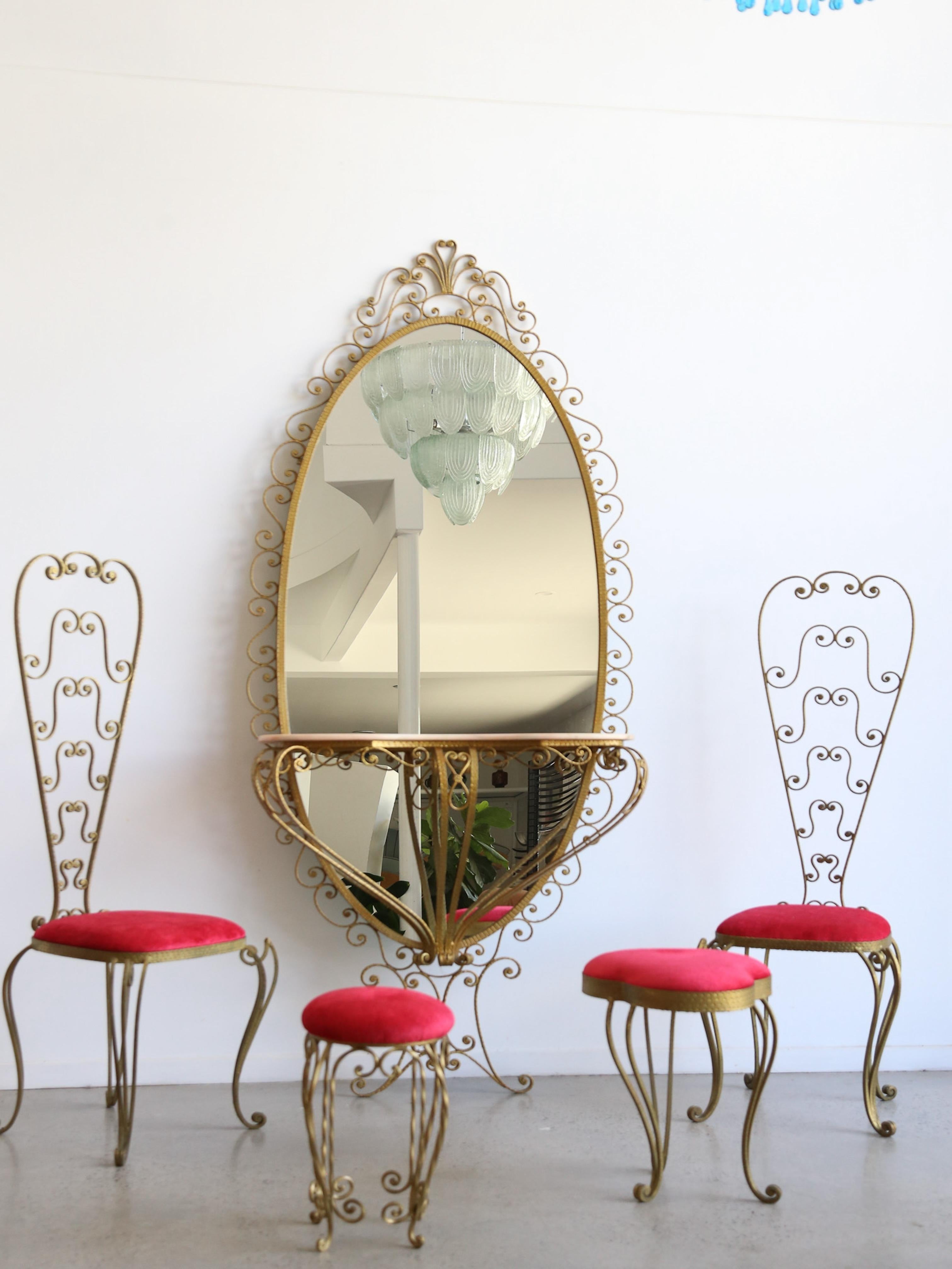 Pierluigi Colli, a renowned Italian designer known for his elegant and intricate designs.

Thi piece was created during the 1940s-1950s, reflecting Art Deco and Baroque revival influences. 

The chairs and mirror frame showcase elaborate wrought
