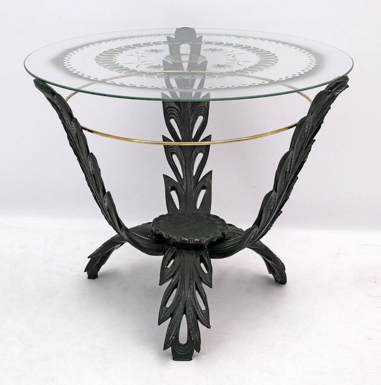 This table was designed by Pier Luigi Colli. The construction has three large simplified but very decorative leaves that contain a small wooden tray in the center, the top in silk-screened glass.

The Colli company was a furniture manufacturer,