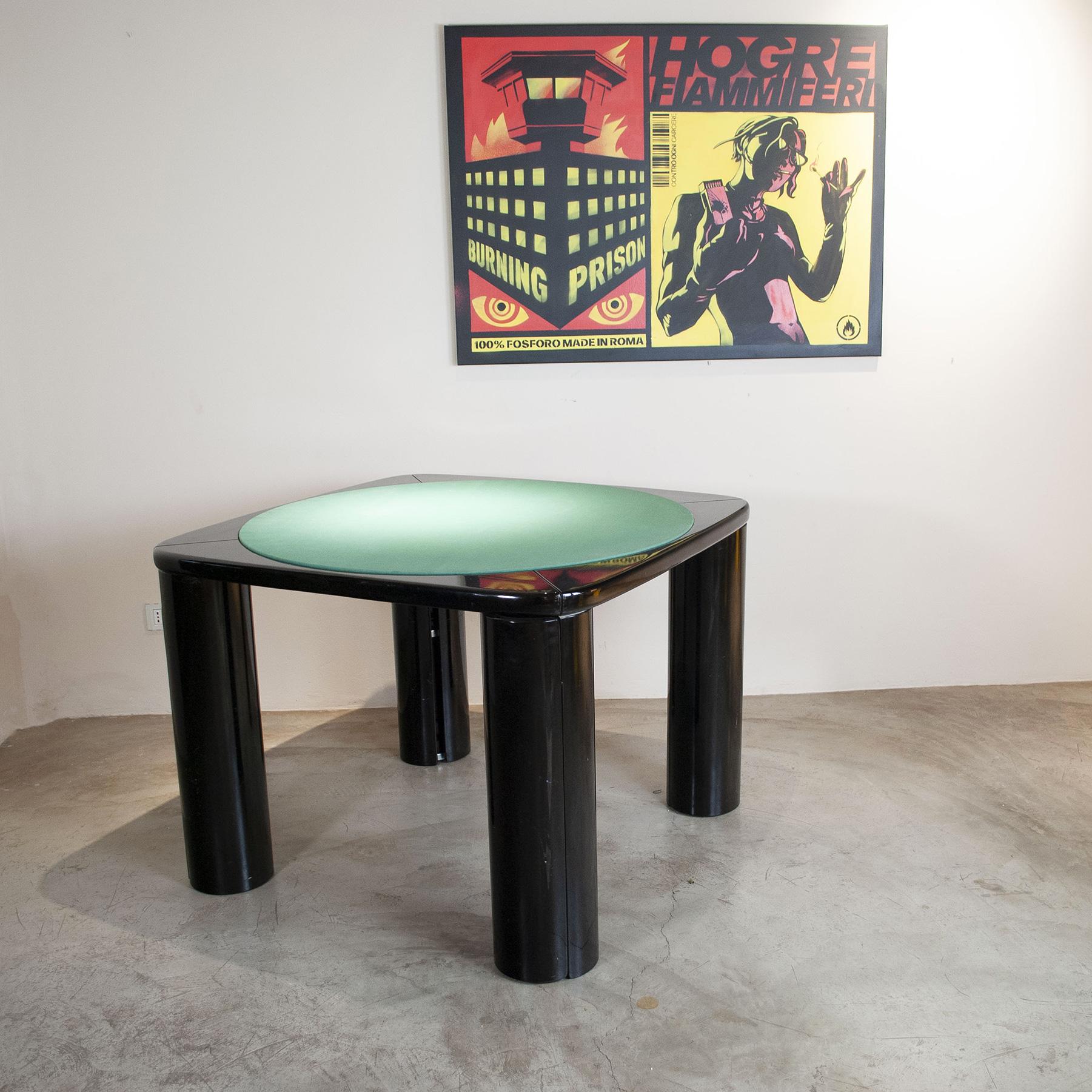 Game table with rotating legs concealing shelves. Designer Pierluigi Molinari production Pozzi, Italy, 1970s/80s. Black lacquered wood, central part of the top covered in green fabric.