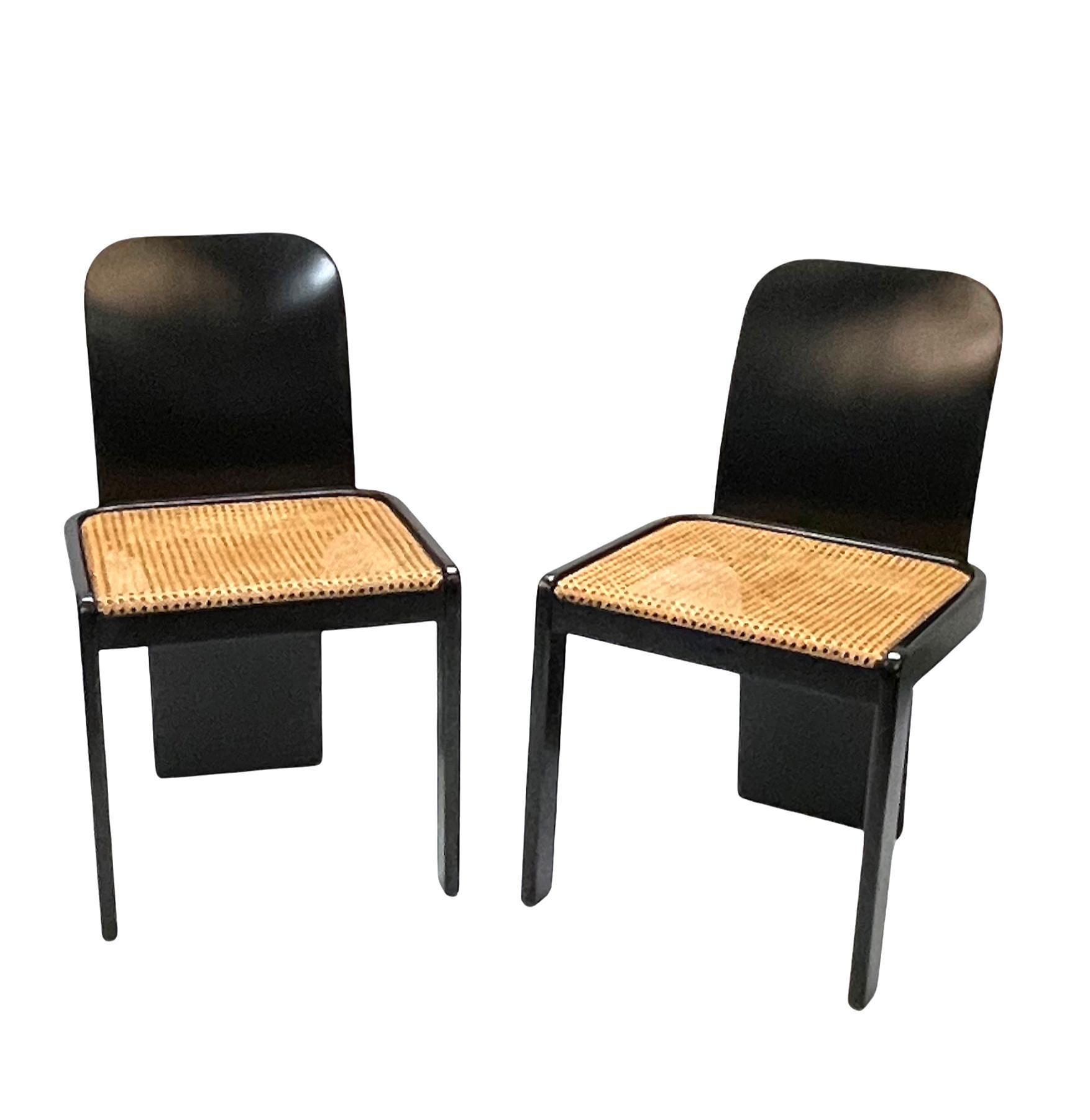 Amazing Mid-Century Modern set of 4 black wooden chairs with Vienna straw seat. These fantastic pieces were designed in Italy during the 1970s by Pierluigi Molinari for Pozzi.

These chairs are unique as they have a characteristic chrome detail on