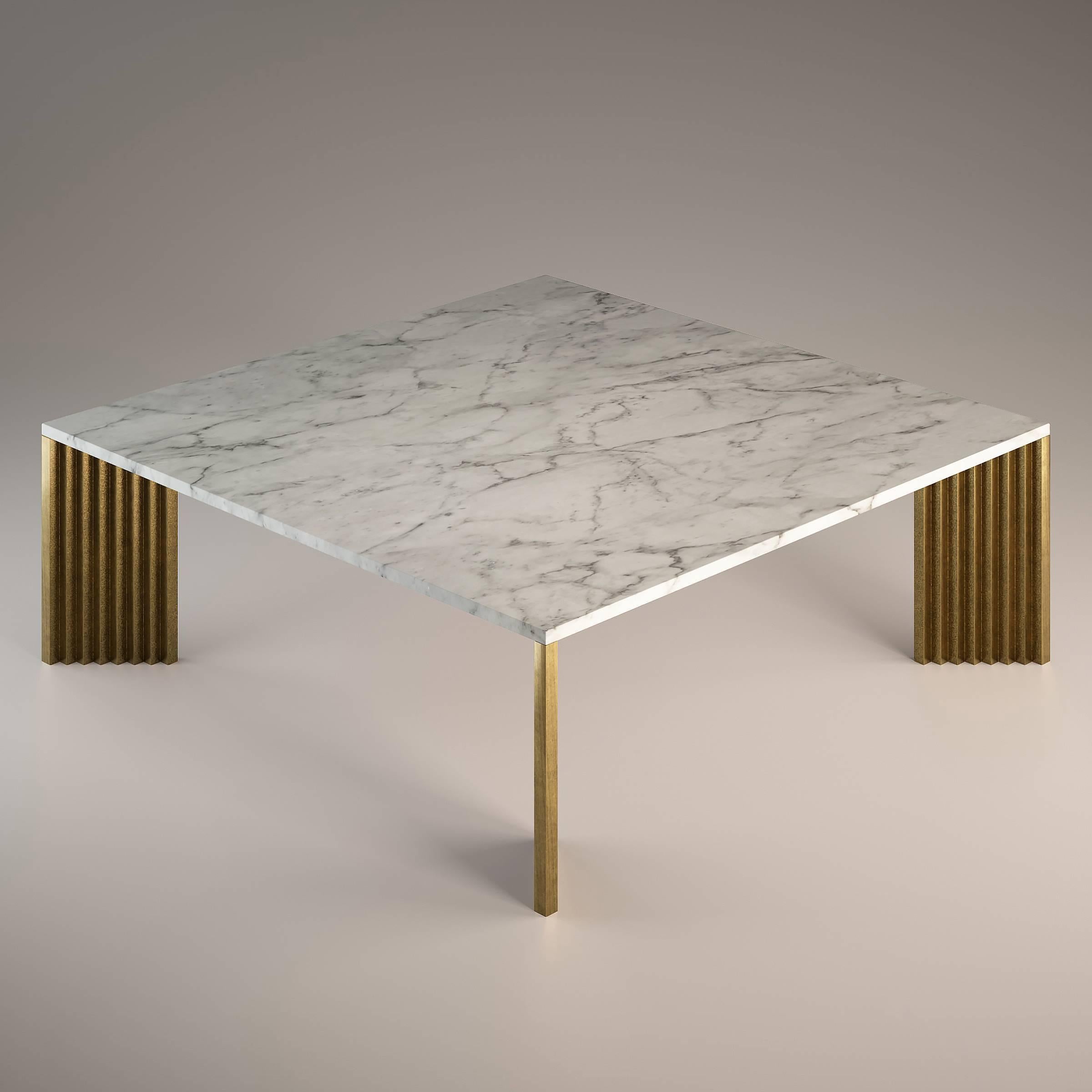 The cast brass legs, with their stepped profiles and diagonal position, appear differently from each viewing angle: sometimes slender, then massive, but also polished and at other times rough.

The top is in white carrara, a marble that is
