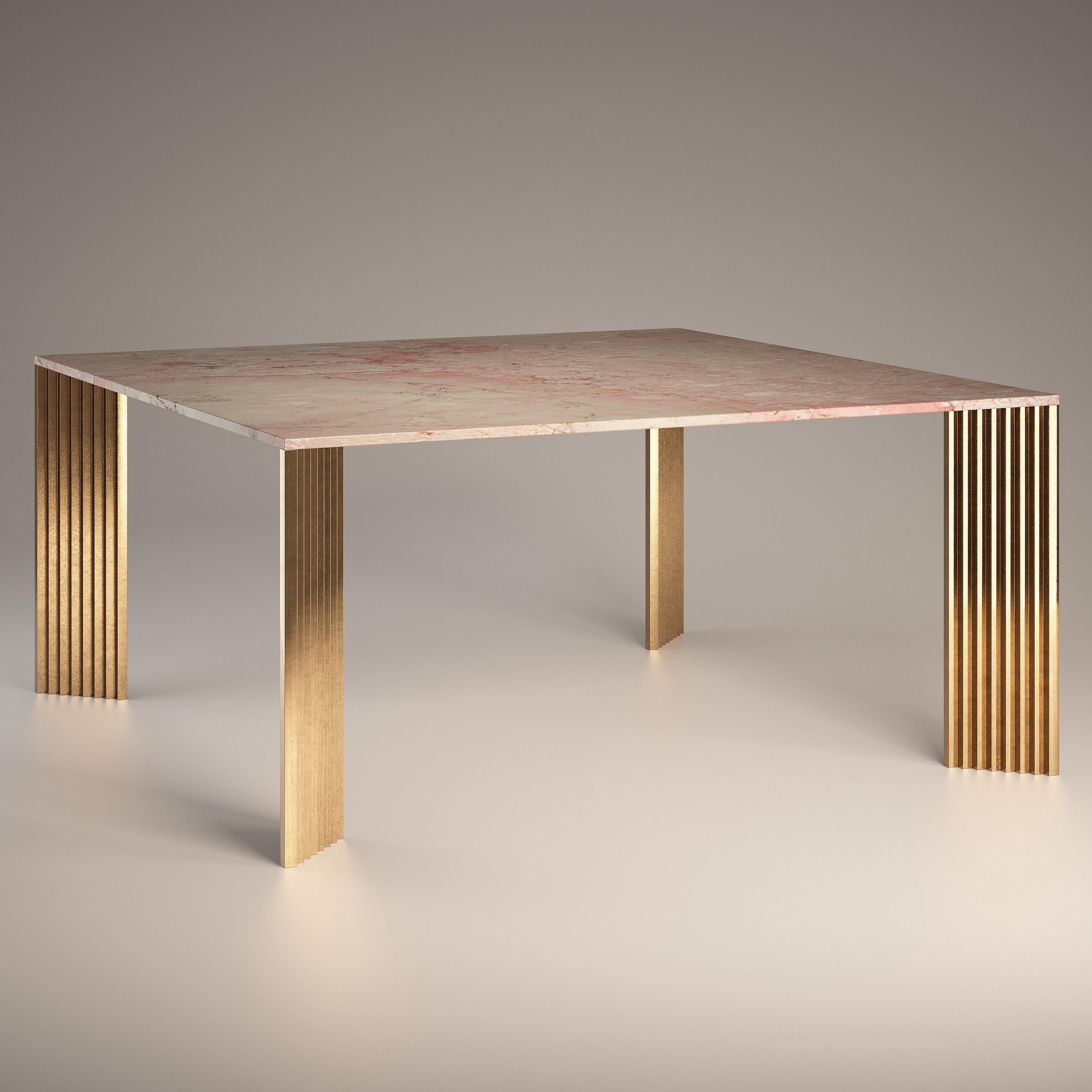 The cast bronze legs, with their stepped profiles and diagonal position, appear differently from each viewing angle: sometimes slender, then massive, but also polished and at other times rough.

The top is in Rosa Tea, a marble that is quarried in