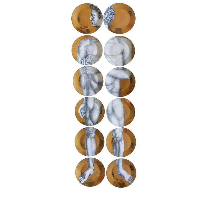 Modern set of gold Adam & Eve Porcelain plates with transfer print images, initially designed by Piero Fornasetti in the 1950s. This complete set has 24 plates, forming the classical biblical images of Adam and Eve with sets of 12 plates each.
Each