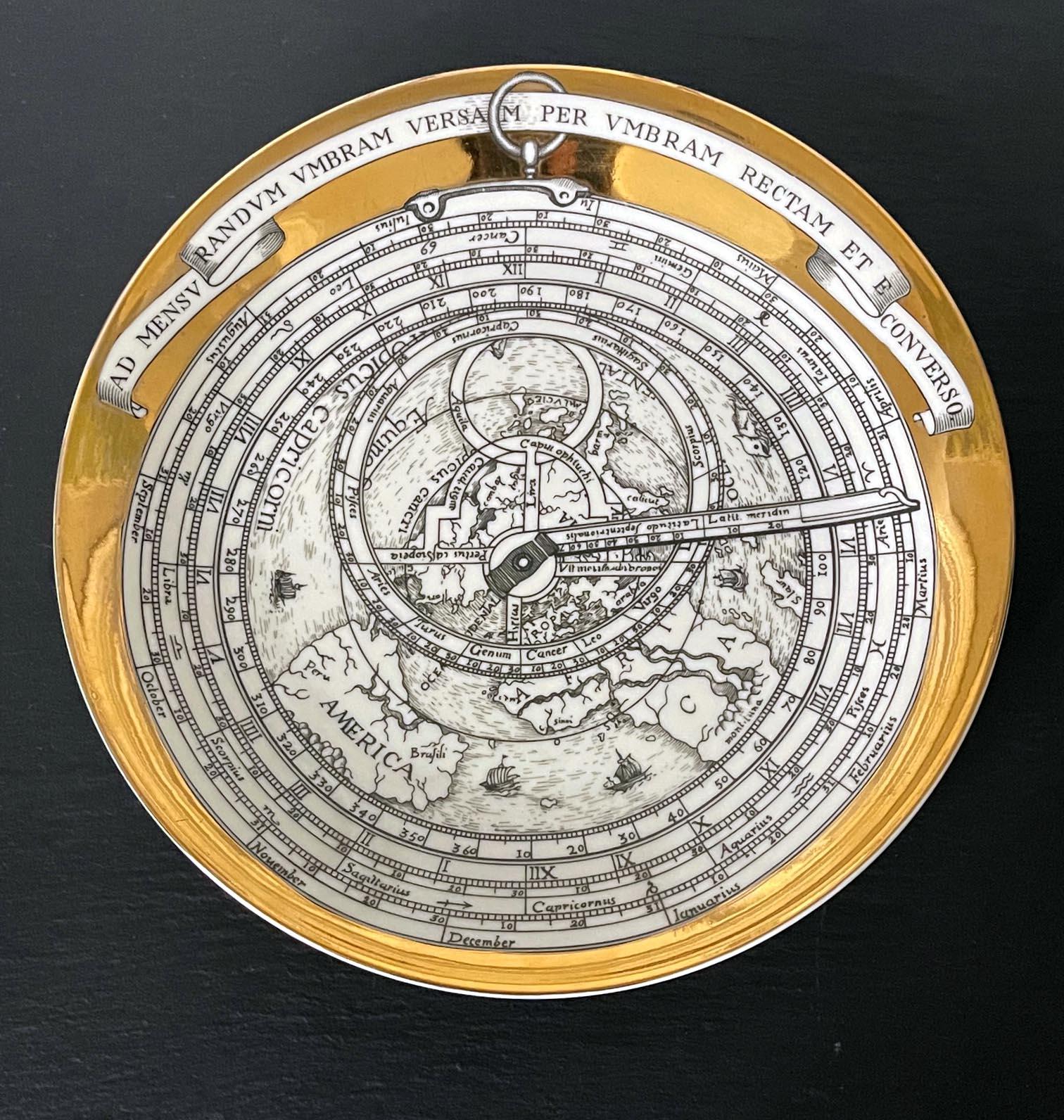 A porcelain plate designed by Piero Fornasetti as no.4 of the twelves-piece set of the Astrolabe series between 1965-1976. The series each depicts an Astrolabio, an elaborate inclinometer of classical antiquity time used by astronomers, navigators,