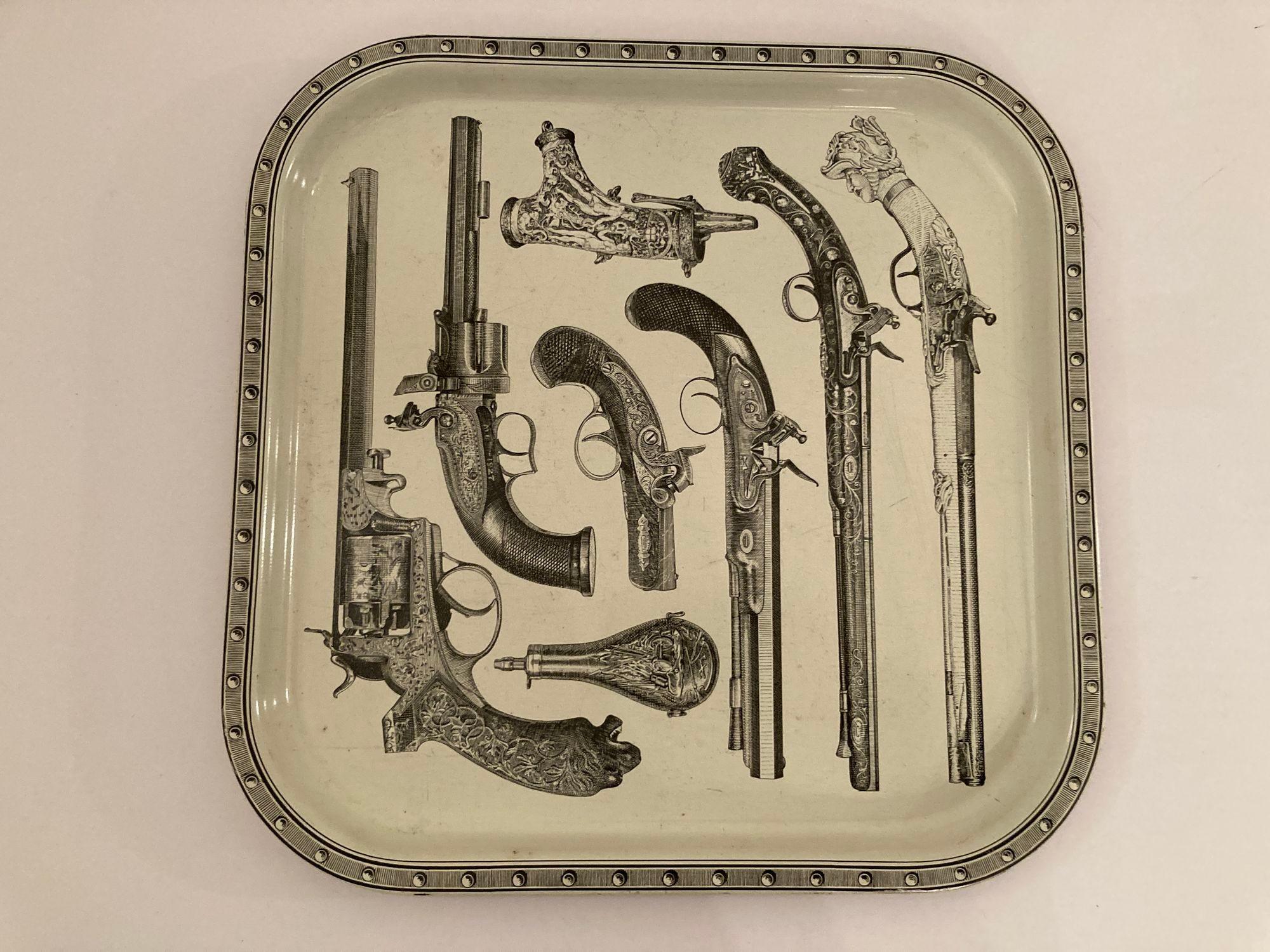 Vintage Pistol And Gun Tray Attributed to Piero Fornasetti, 1960s.
This is a great studio Fornasetti, Piero Fornasetti style Pistol Barware Metal Serving Tray.
Very decorative Piero Fornasetti's Iconic square enameled metal tray featuring antique