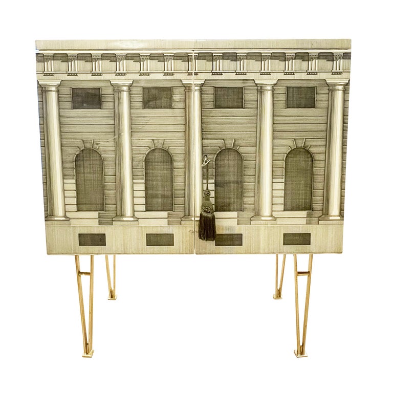 1960’s Piero Fornasetti cabinet with brass legs featuring an architectural motif.

Condition: Excellent vintage condition, minor wear consistent with age and use. Legs are new.

Measures: Width: 27.5”

Depth: 14”

Height: 31.5”.

