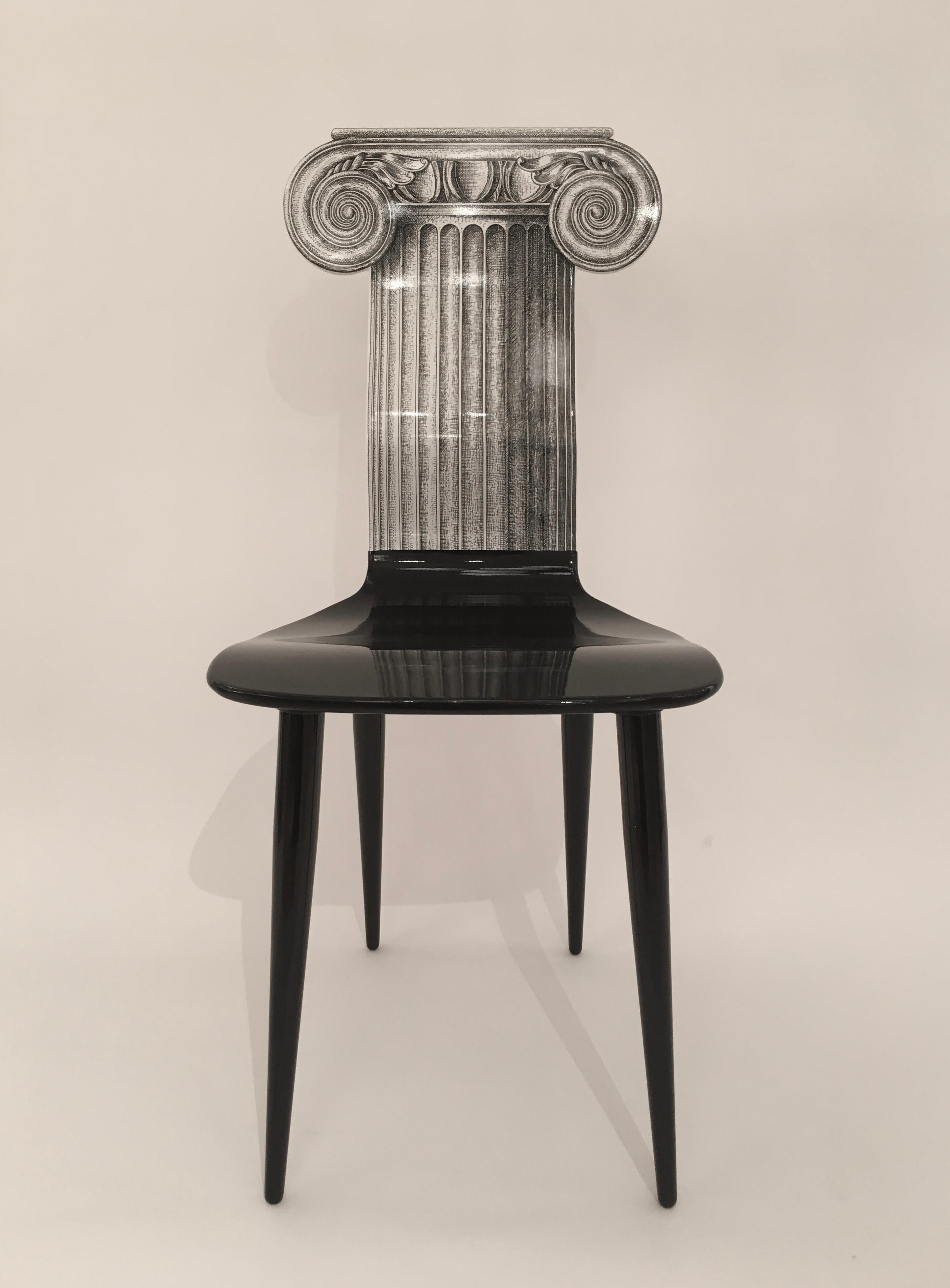 A wonderful 'Capitello Ionico' or 'Ionic Capital' wooden chair designed by the great Piero Fornasetti. Originally designed in the 1980, this particular chair is numbered #24 from a very limited number in 2006. In fantastic condition, this is one of