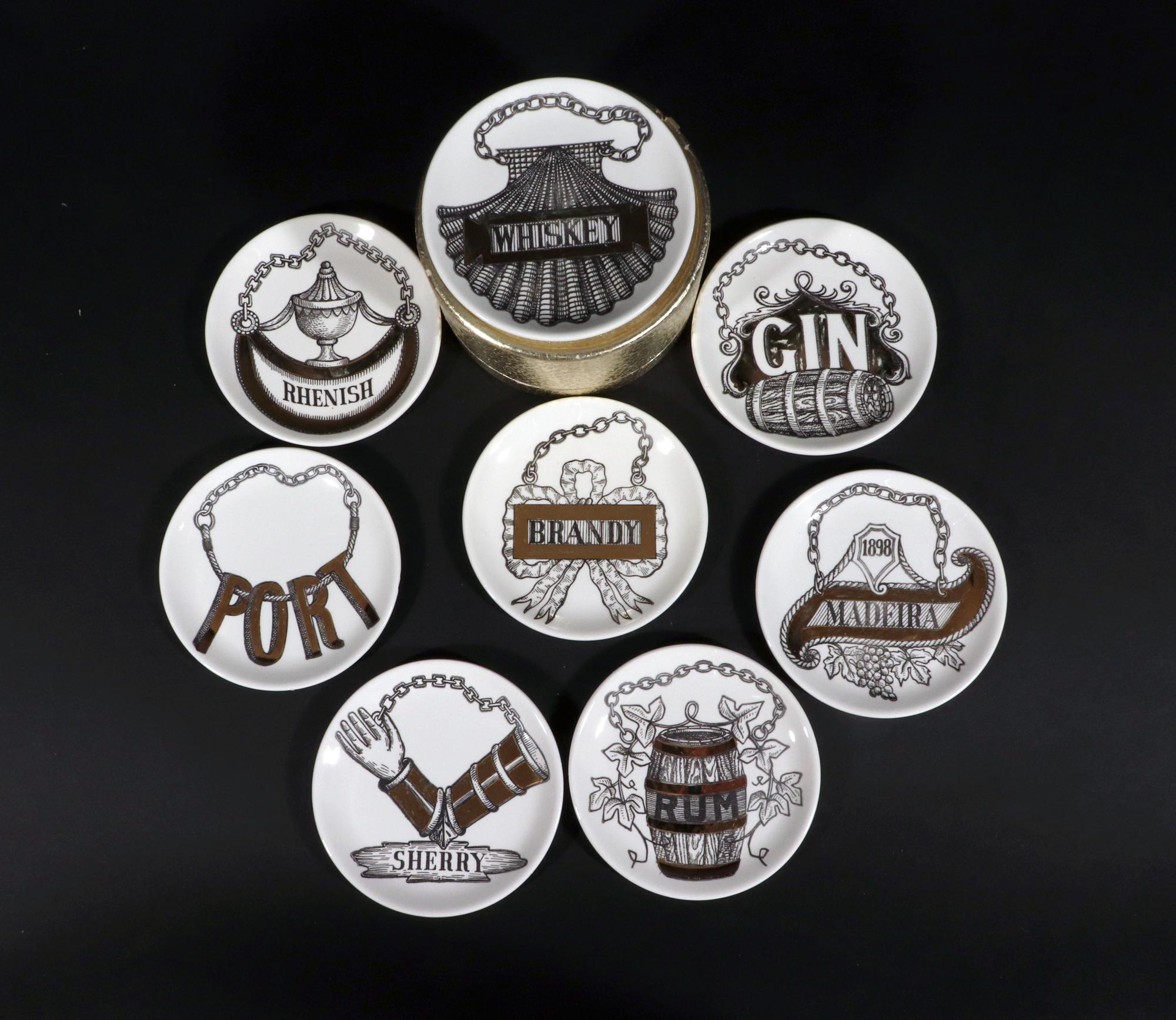 Piero Fornasetti Wine & Liquor Coasters,
Vini E Liquori Pattern,
1950s.

The charming complete set of coasters named Gin, Rum, Sherry, Madeira, Port, Rhenish, Brandy, and Whiskey.  Each coaster is printed in black and white and highlighted in