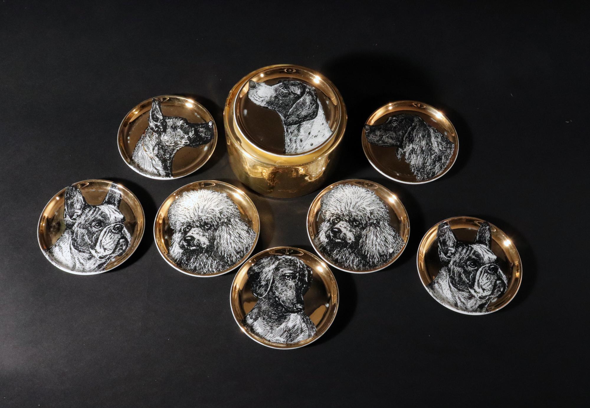 Piero Fornasetti Ceramic Coaster Set of Eight Decorated with Dogs,
Cani Pattern (Dogs),
Within Original Gold Foil Box,
1950s

This rare set of Piero Fornasetti ceramic coasters is rarely found.  Each coaster has a gold ground and a different black