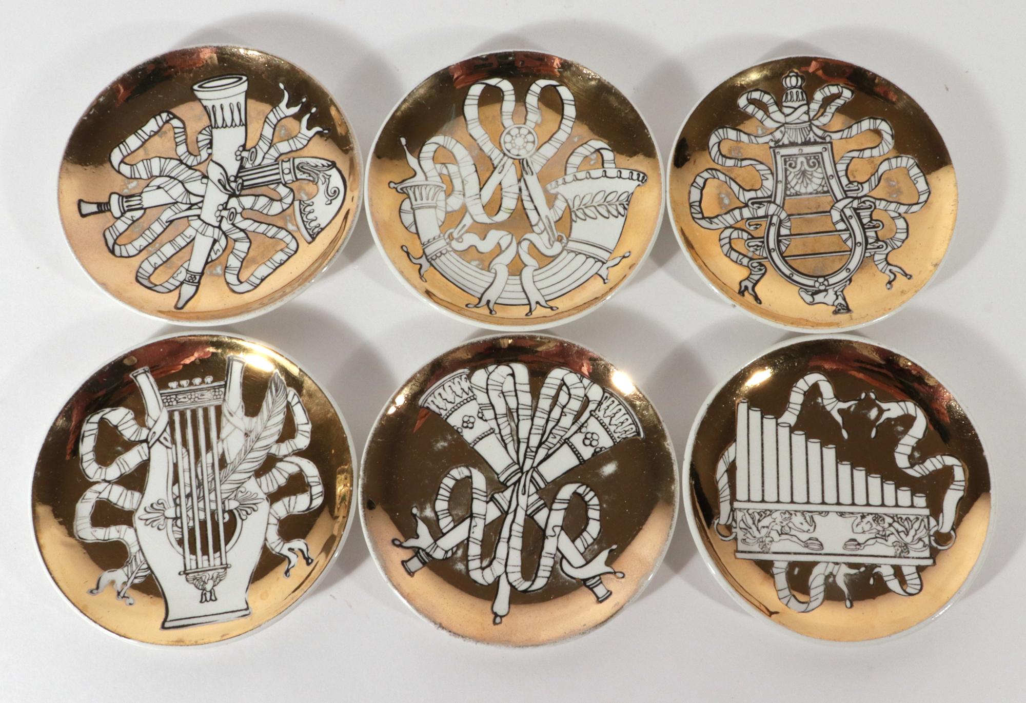 Piero Fornasetti Ceramic Coasters,
Musicalia Pattern,
Set of Six
Early 1950s-60s

Each coaster with a different historical neoclassic musical instrument entwined in ribbons, outlined in black, and set upon a gold ground.  The original green box with