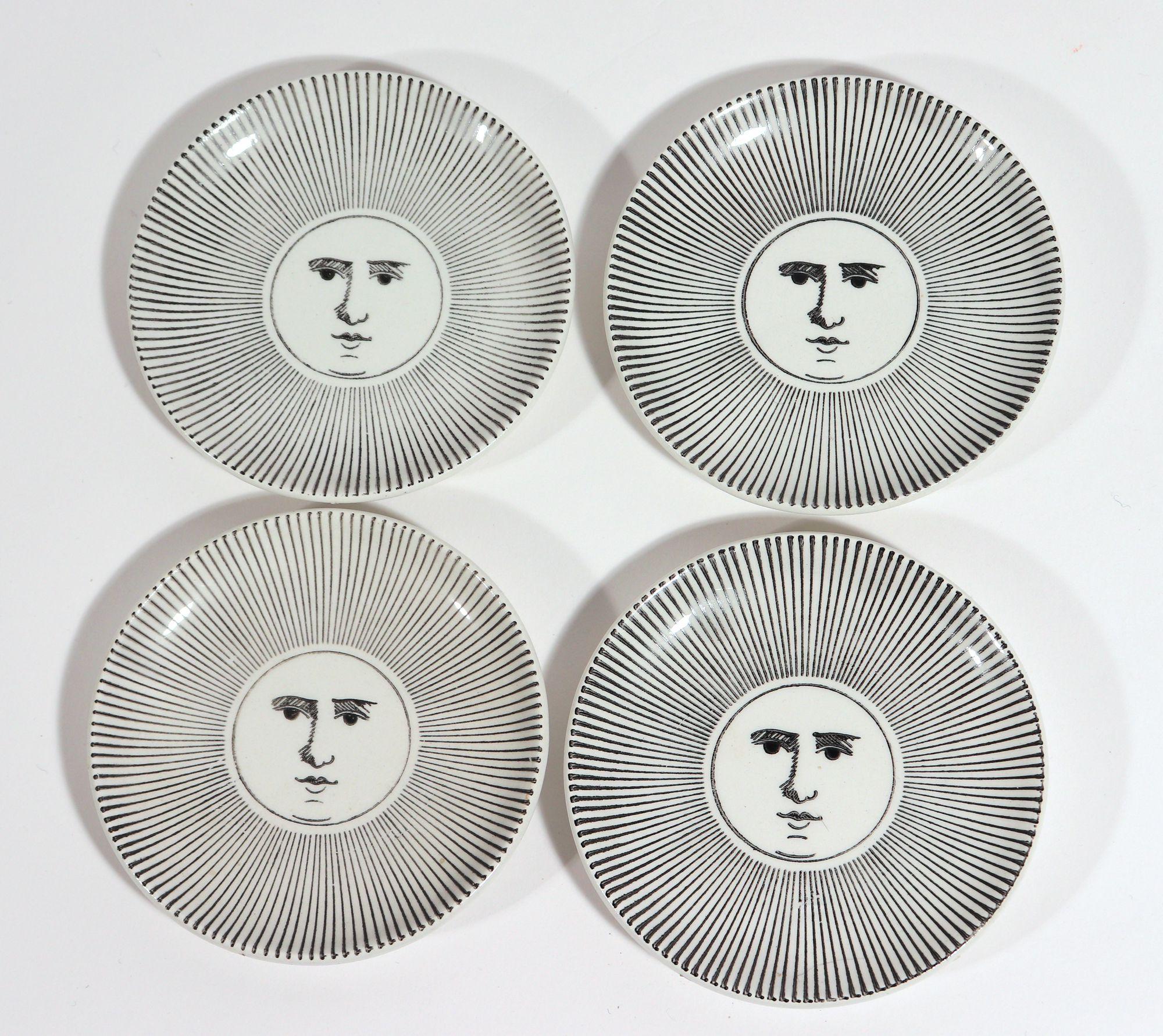 Piero Fornasetti ceramic small coasters Soli E Lune- Sun and Moon,
1950s

The small circular complete set of black and white ceramic coasters depict eight moon designs of the same design with a central Luna face and an outer band of rays. This