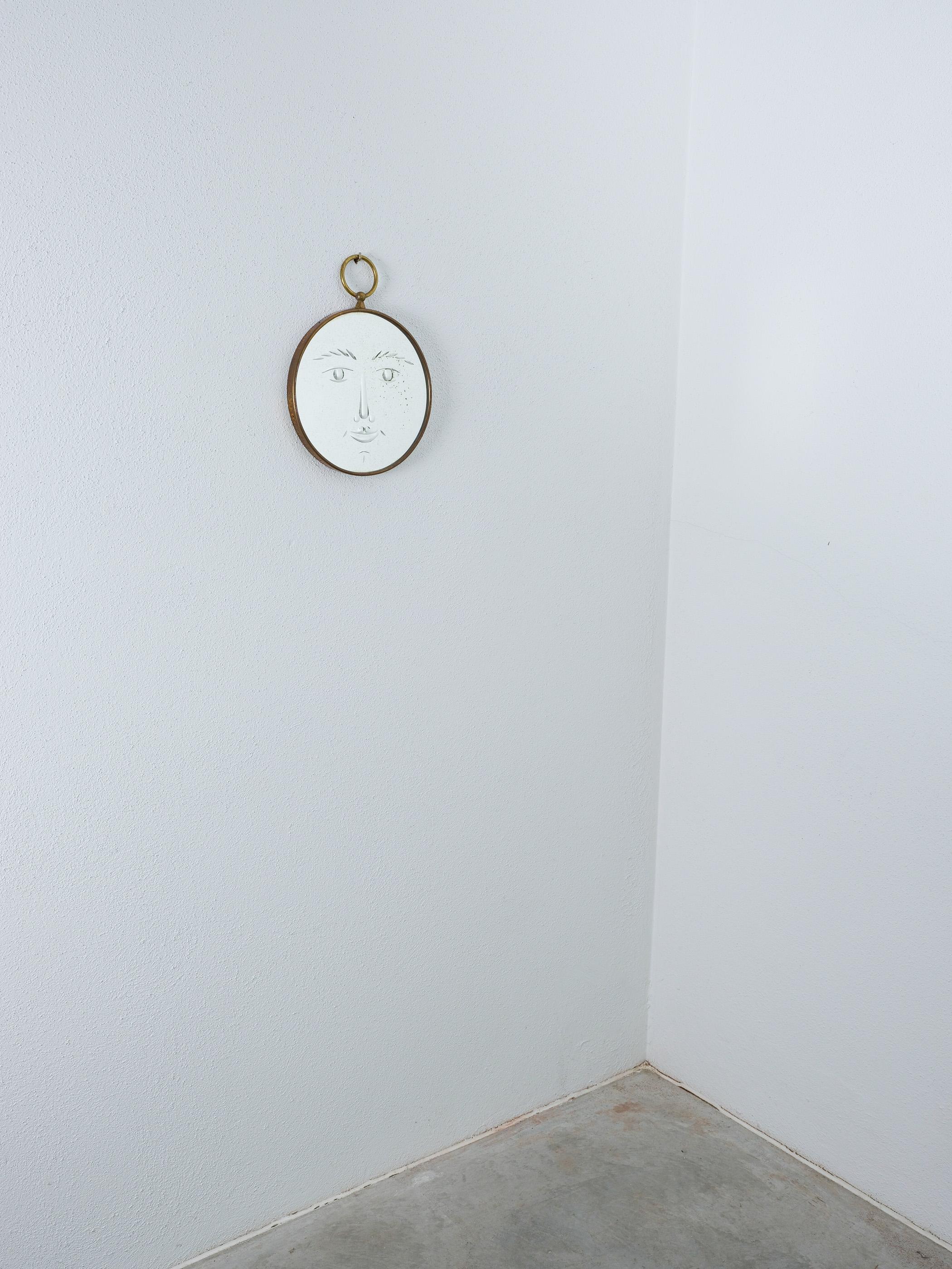 Piero Fornasetti Face Mirror 'Viso' Wall Mirror Brass, Italy, circa 1955

Very rare, surrealistic face mirror 'Viso' by Piero Fornasetti, Italy, from the early late 1950's, early 1960- collectors piece.
Slightly smiling, charming original mirror by
