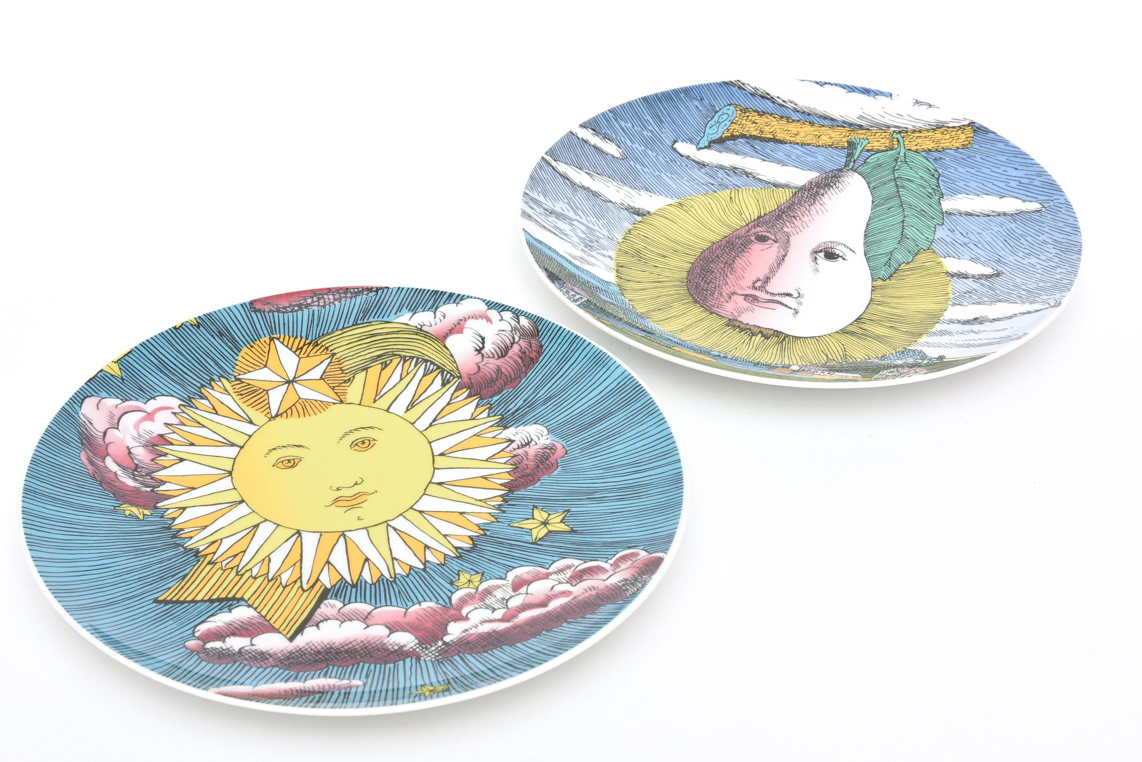 These delightful and whimsical Piero Fornasetti set of 2 porcelain hand painted plates are from a series called Mesi and Soli. They were executed by Rosenthal Germany between the 1960s and 1980s. They are great for serving or hanging on your wall.