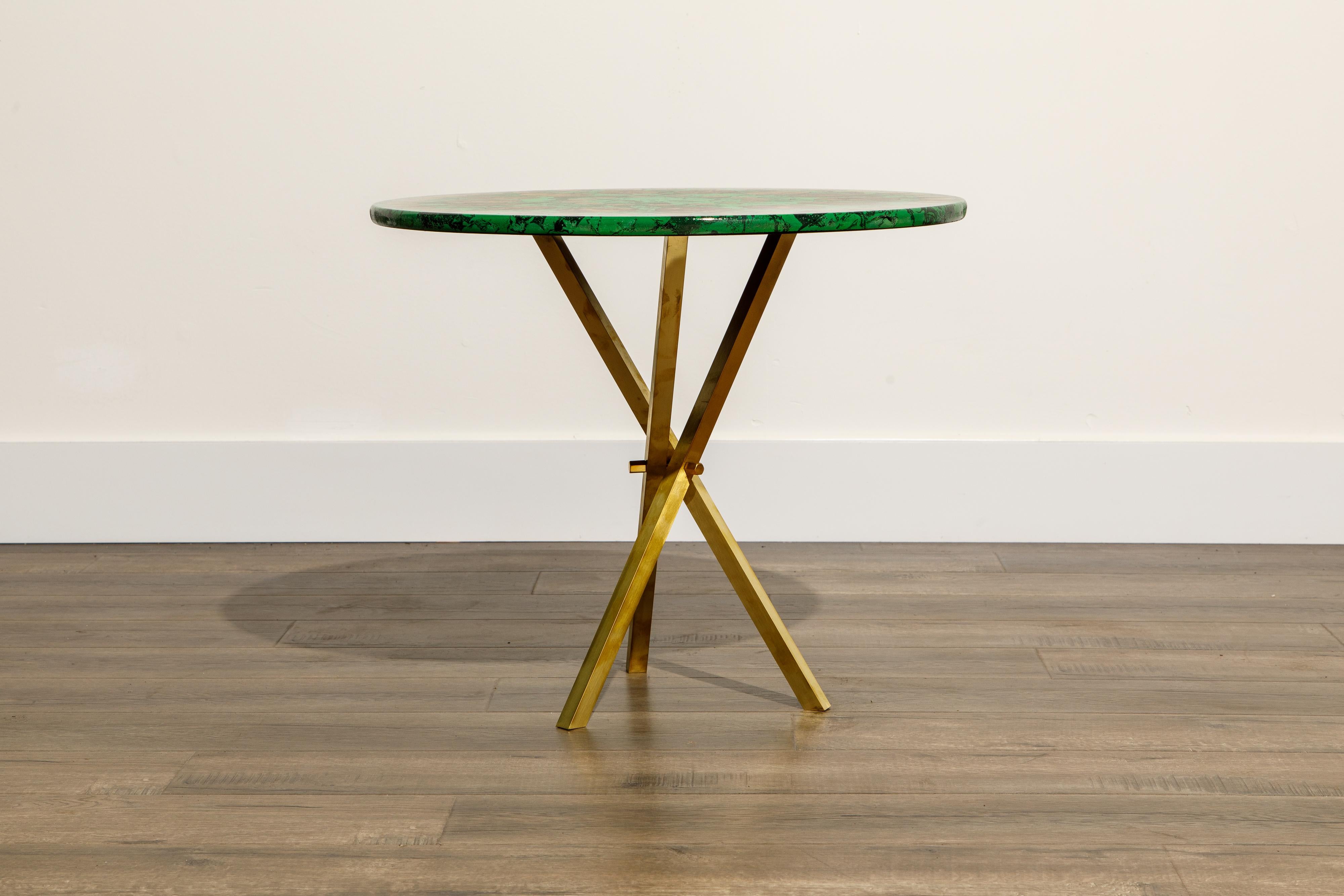 This gorgeous collectors item is a 'Cammei' side table by Piero Fornasetti, signed underneath with its original label. The side table is made with lacquered wood that has a green marble and gold cameo motif and is affixed on top of a brass tripod