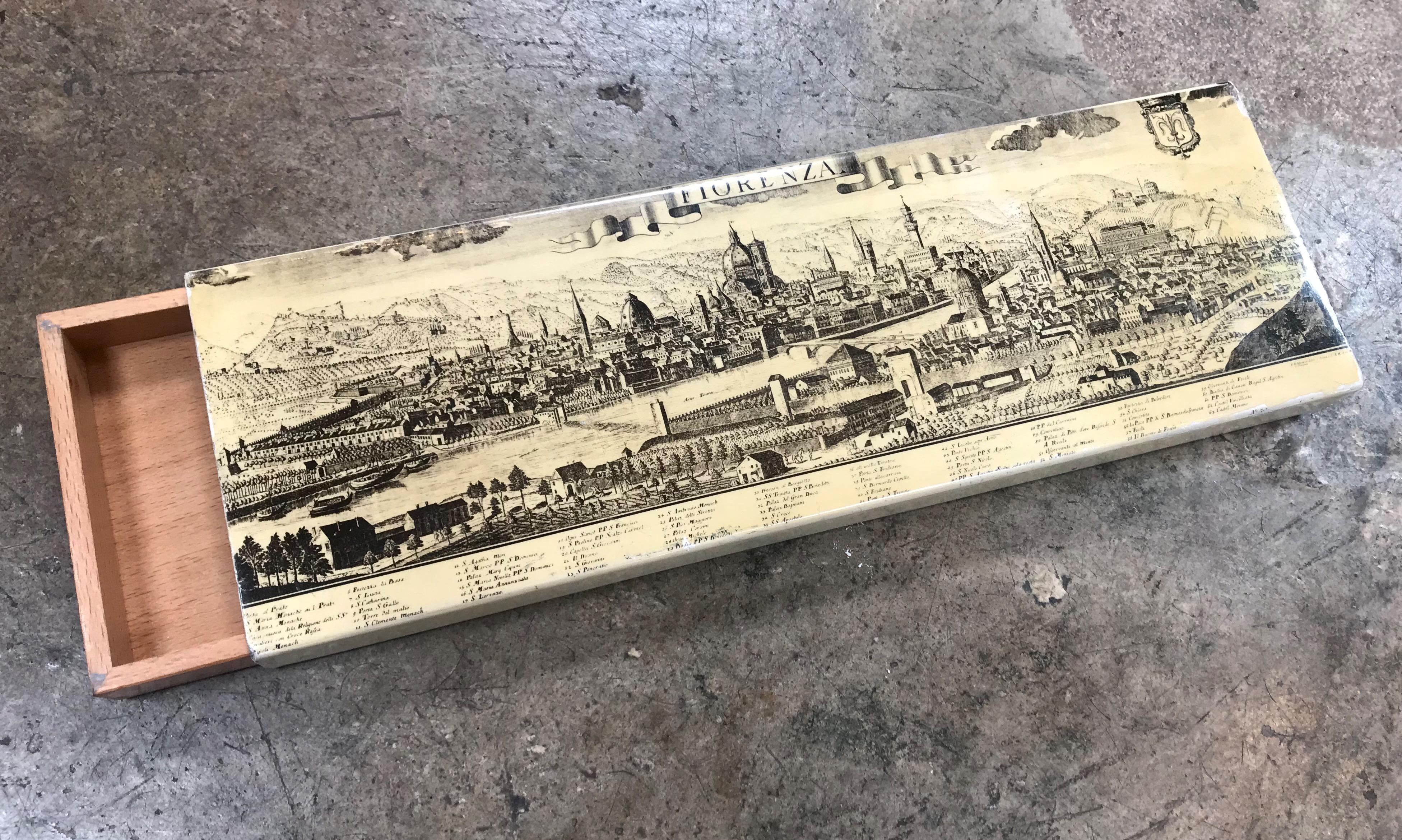This is a wonderful vintage Piero Fornasetti box. It has a enameled metal cover with an iconic image of ancient printed view of Florence (Tuscany, Italy) and a wooden two-compartment box. The bottom is grey felt. Manufactured by Fornasetti Milano.
 