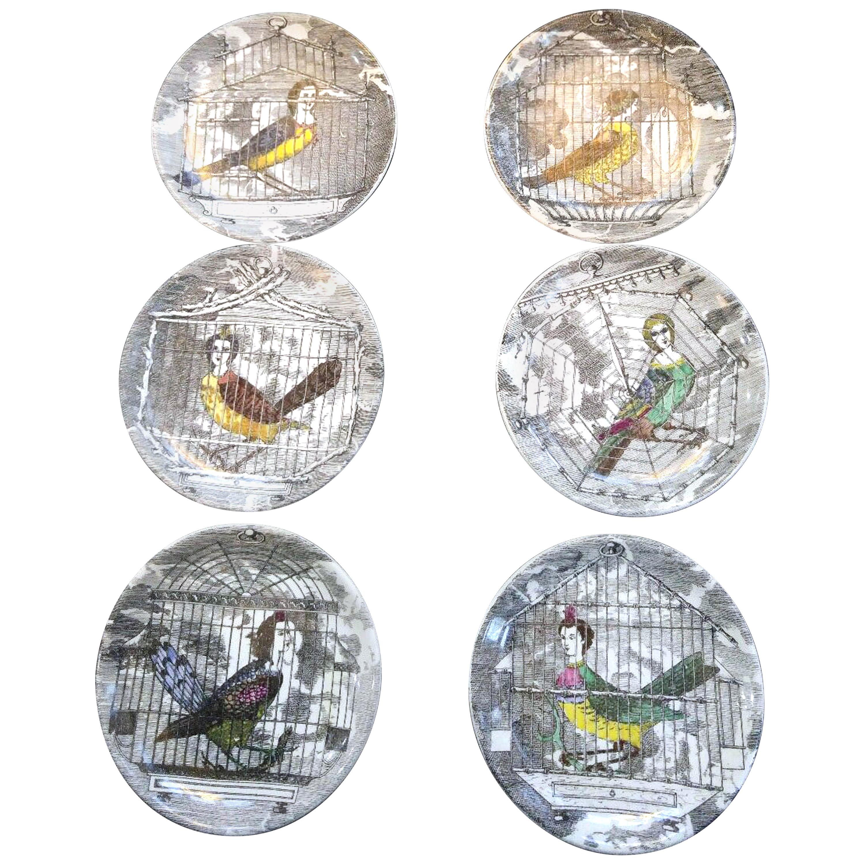 Piero Fornasetti Le Arpie Gentili coaster set and box, 
circa 1960.

A set of six coasters each depicting a caged female harpy with the original gold box.

Diameter: 4 inches

Harpy- In Greek mythology and Roman mythology, a harpy (plural