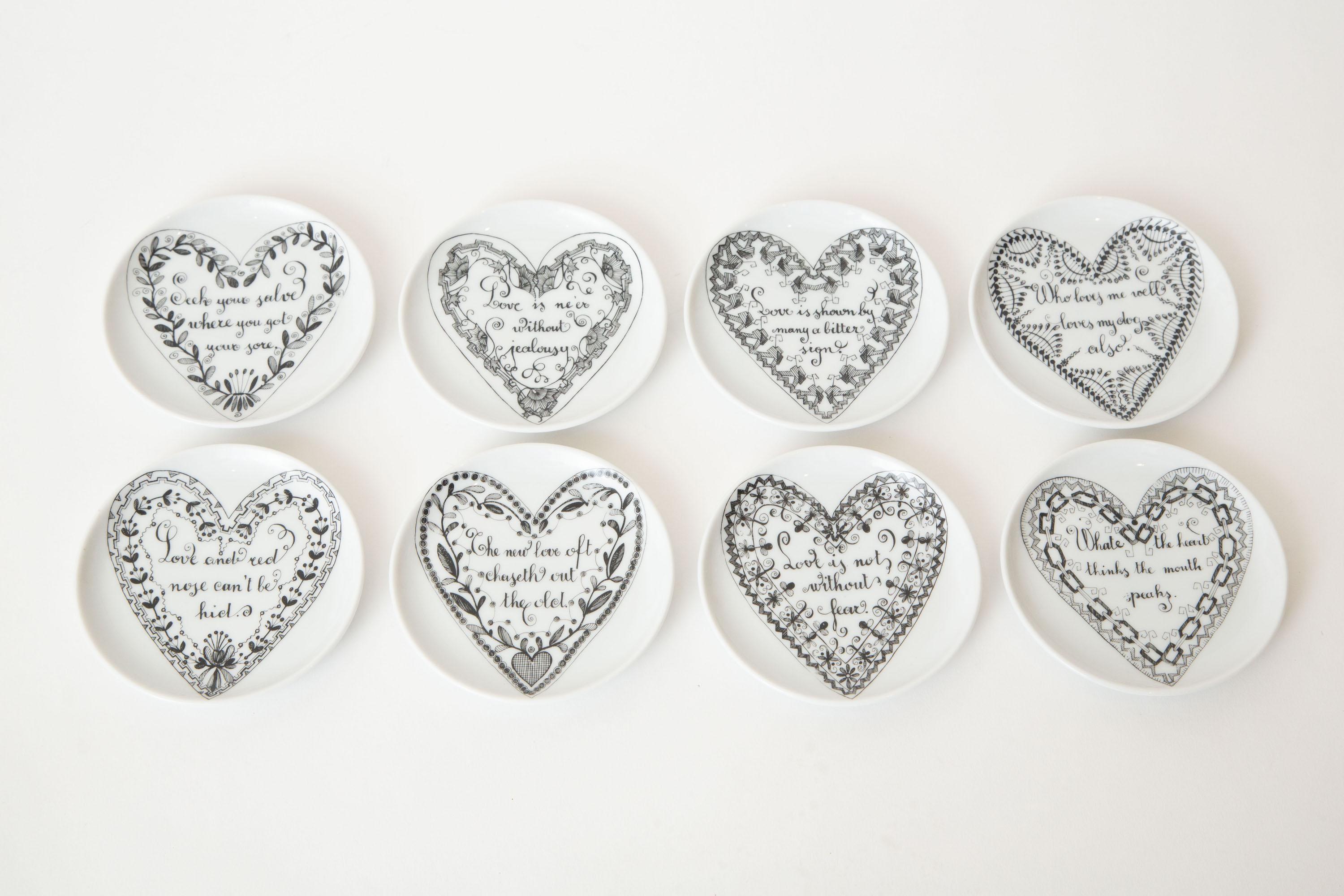 This delightful and heart felt set of classical Roman vintage Piero Fornasetti porcelain love coasters are white porcelain with black sayings in heart form. This is a complete and wonderful set of 8; great barware and or for serving. Mid-Century