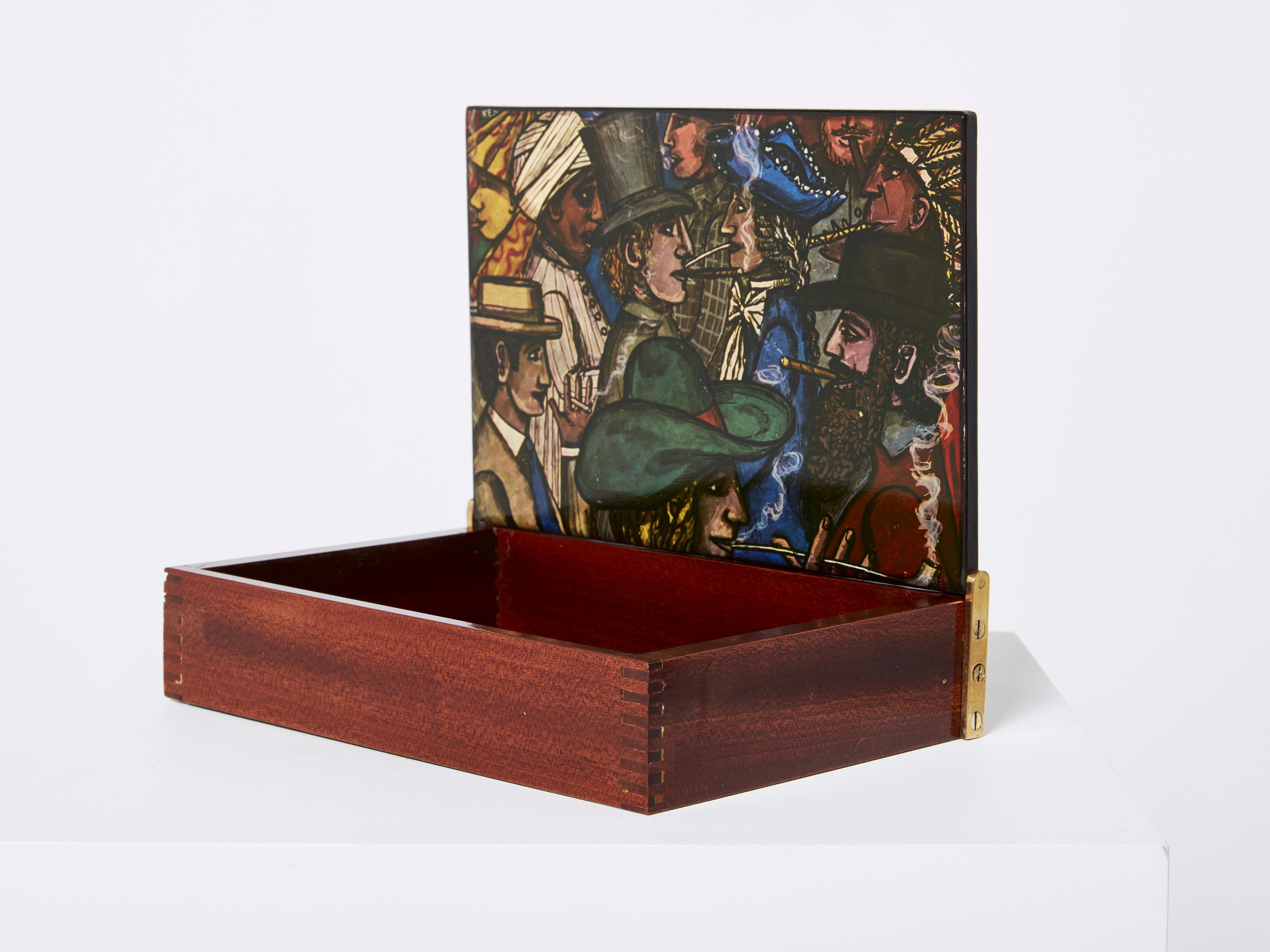 Beautiful Piero Fornasetti decorative box made in Italy in the 1950s. This box is carved from mahogany wood, with painted varnished wood on both sides of the top, and brass side hinges. A collectible piece, perfect as a gift, with a very nice