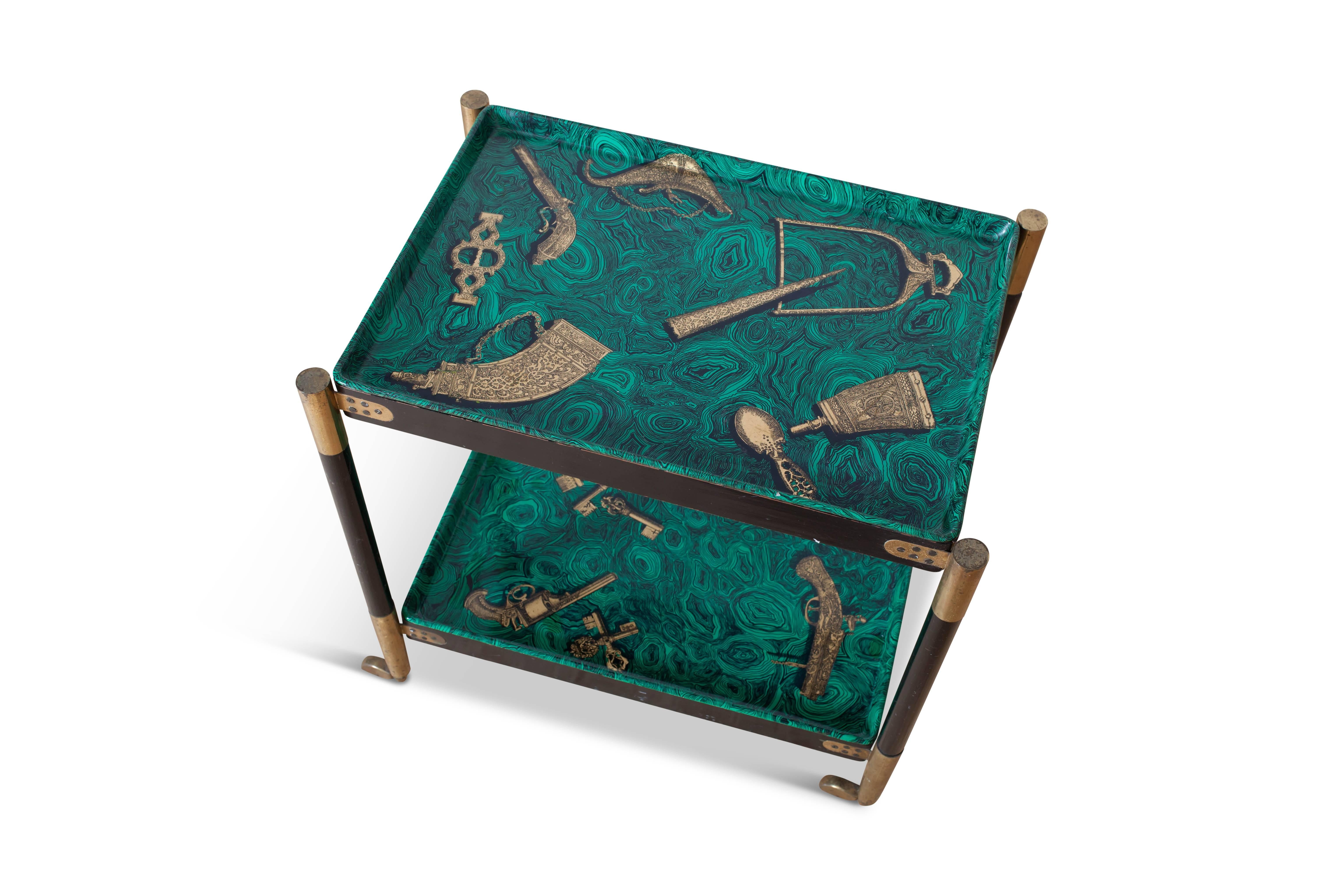 Stunning serving or bar cart by Italian designer Piero Fornasetti, Italy, 1960s

The frame consists of black lacquered wood with brass hinges and wheels.
The two interchangeable trays show images of 18th century pistols and attributes
in gold