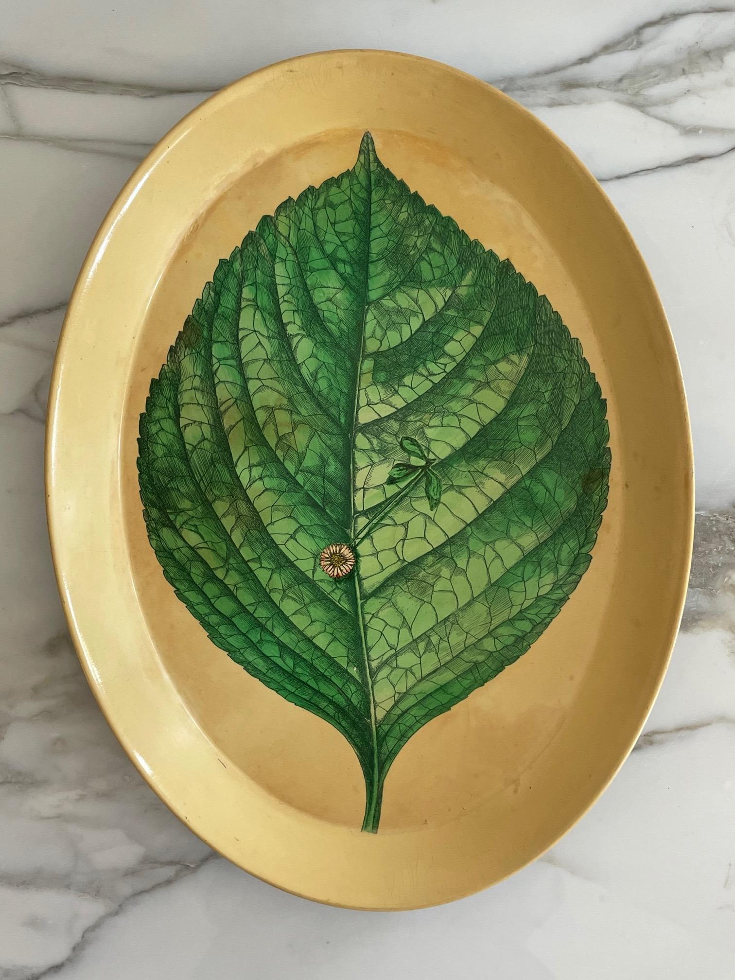 An unusual Piero Fornasetti metal tray with a stylized leaf decoration. Beautiful example with patina, signed on the back.