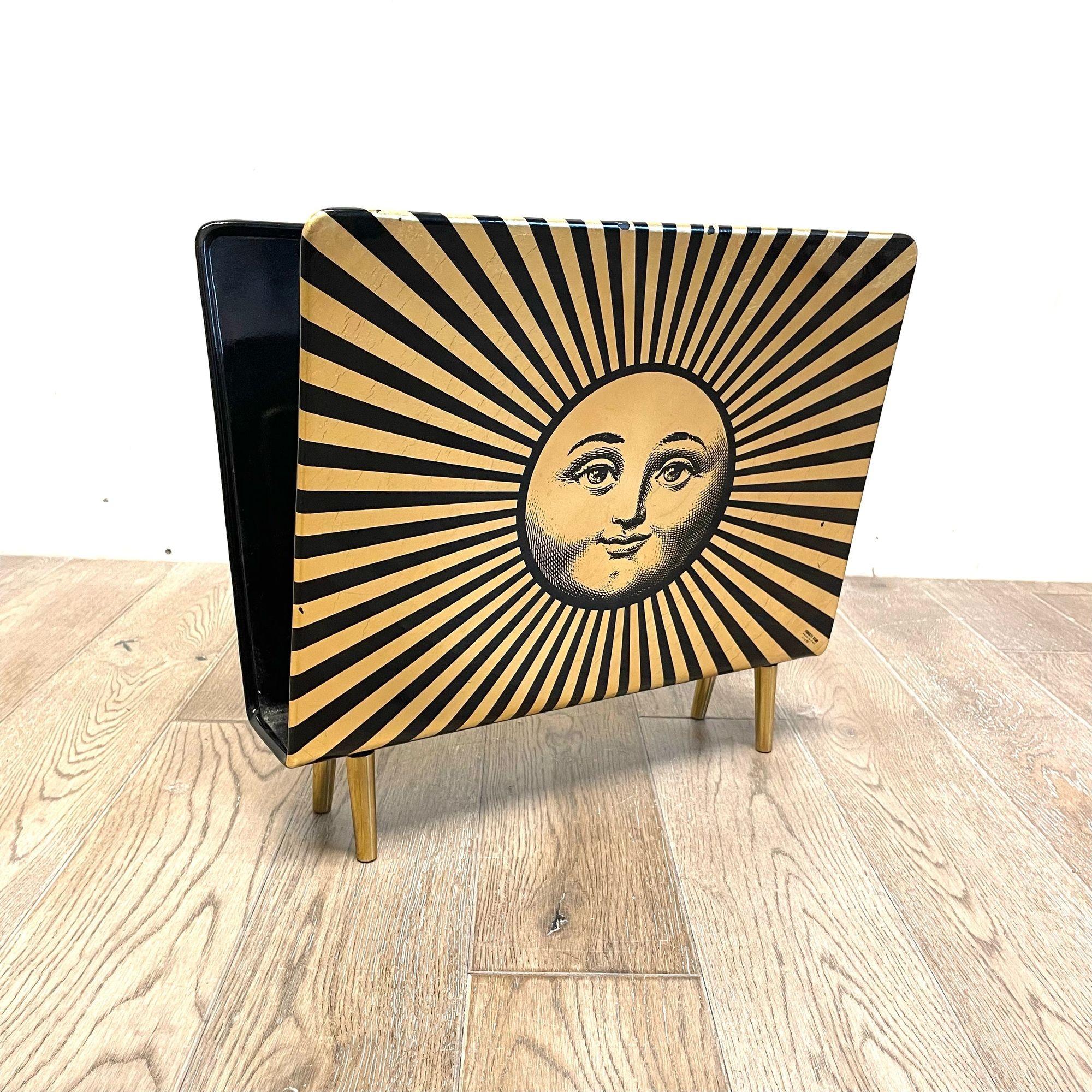 Piero Fornasetti, Mid Century Modern, Magazine Rack, Lacquer, Metal, Italy 1960s

A rare Piero Fornasetti labeled and numbered no. 1 of 98 having a lacquered metal and brass form. The decorative design depicting a sunbrust smiling face with black