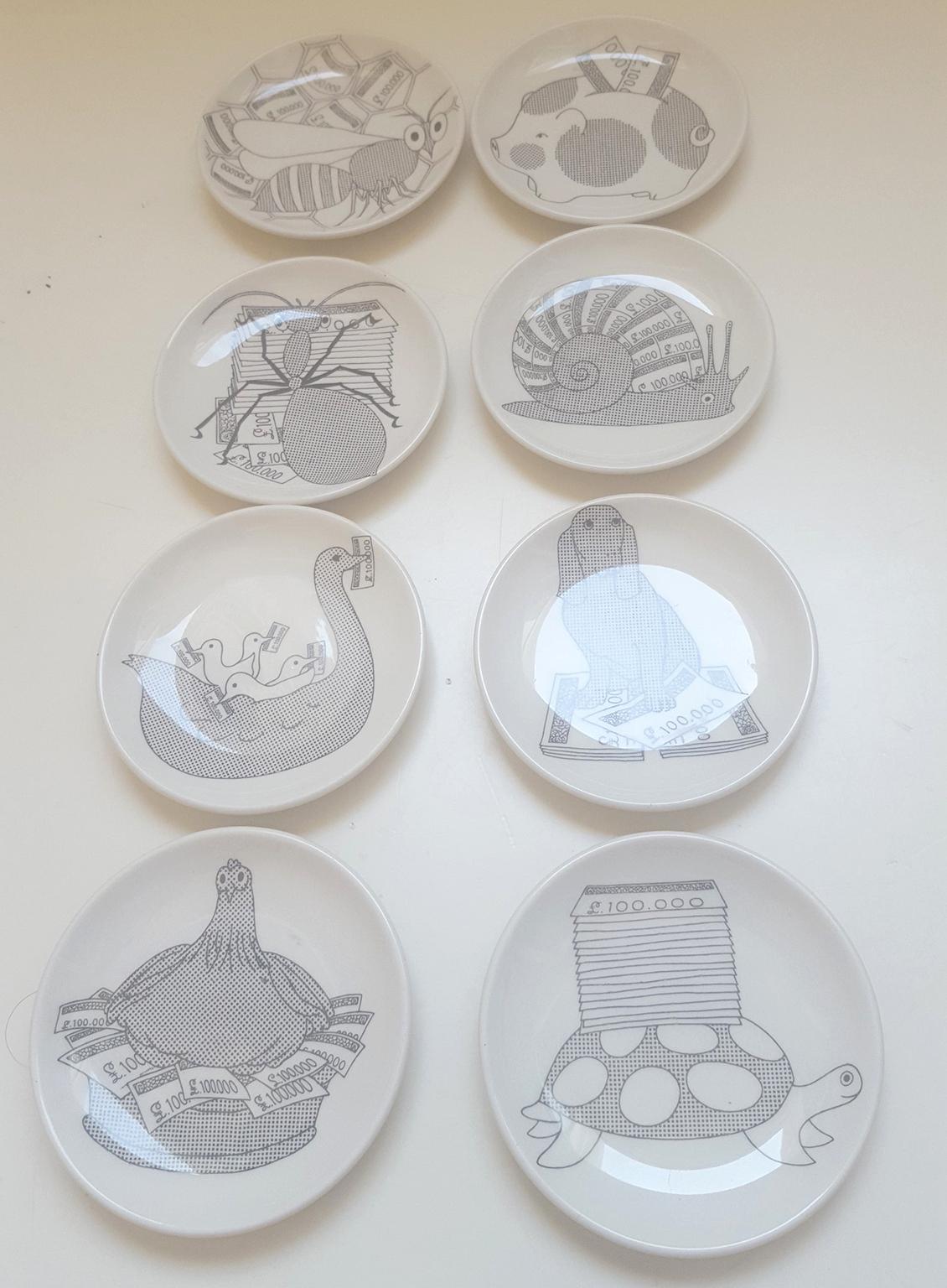 A set of eight coasters /small plates, in the original gold coloured box;
designs of animals with symbol of Lira Italiana.
White ceramic decirated with silk-screen printing.
Marked Fornasetti Milano with graphical symbol
Never used.