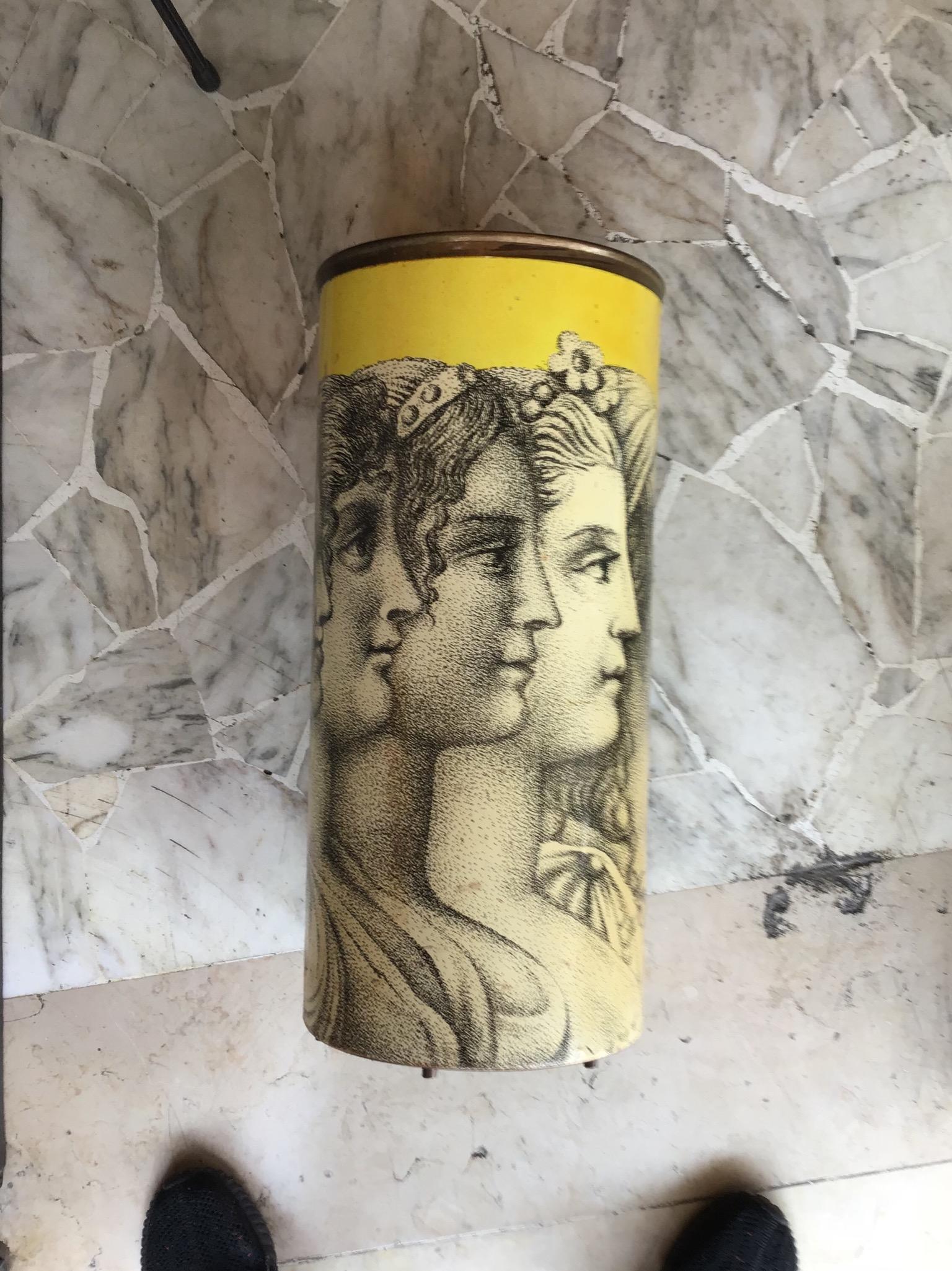 Charming Fornasetti midcentury yellow umbrella stand with figures, 1950. Painted iron and brass.