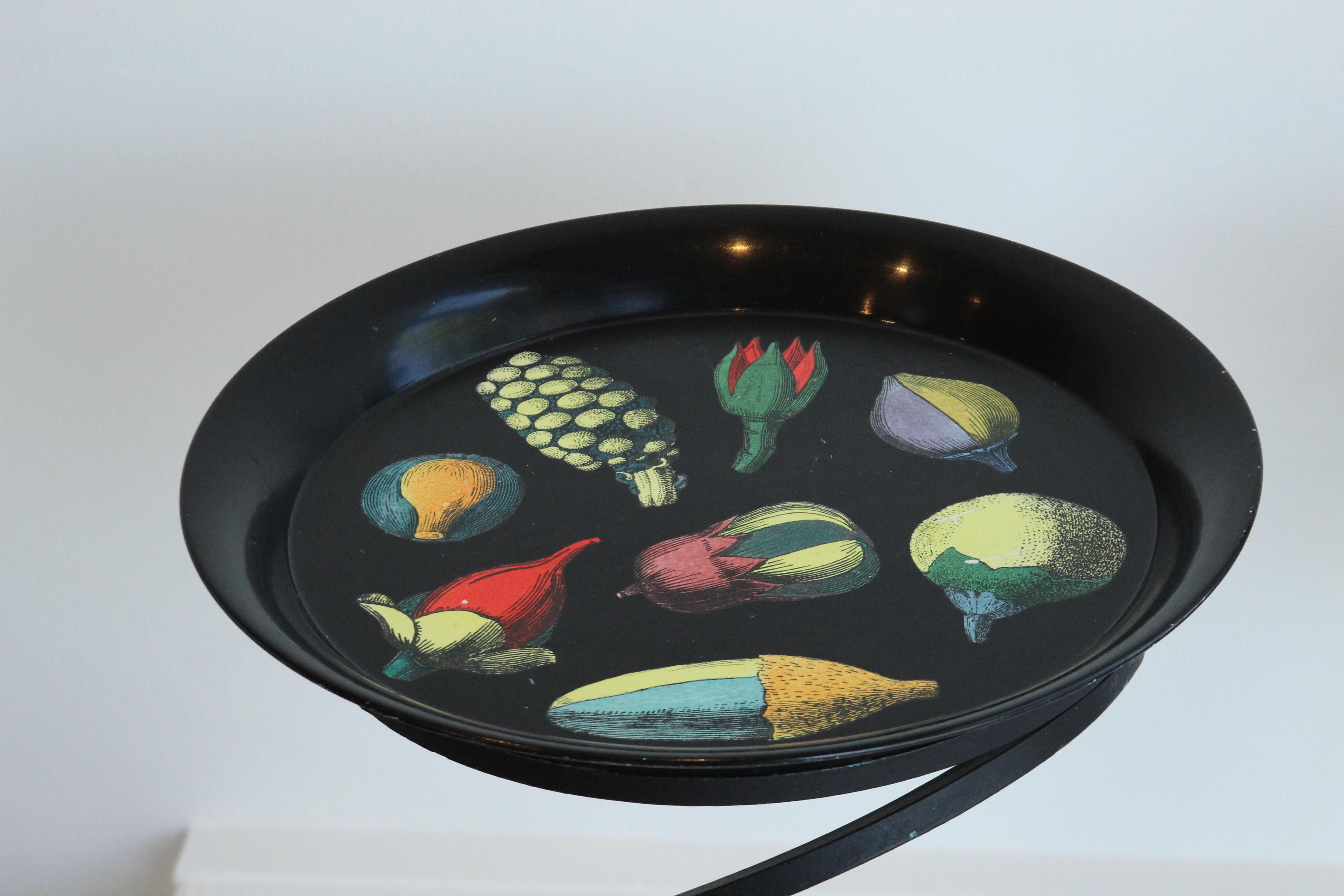 Black lacquered metal tray with hand painted images of squashes, pumpkins, and gourds, made in the 1950s by the workshop of Piero Fornasetti. The striking, vivid colors against the black background make this piece a real eye catcher. It would look