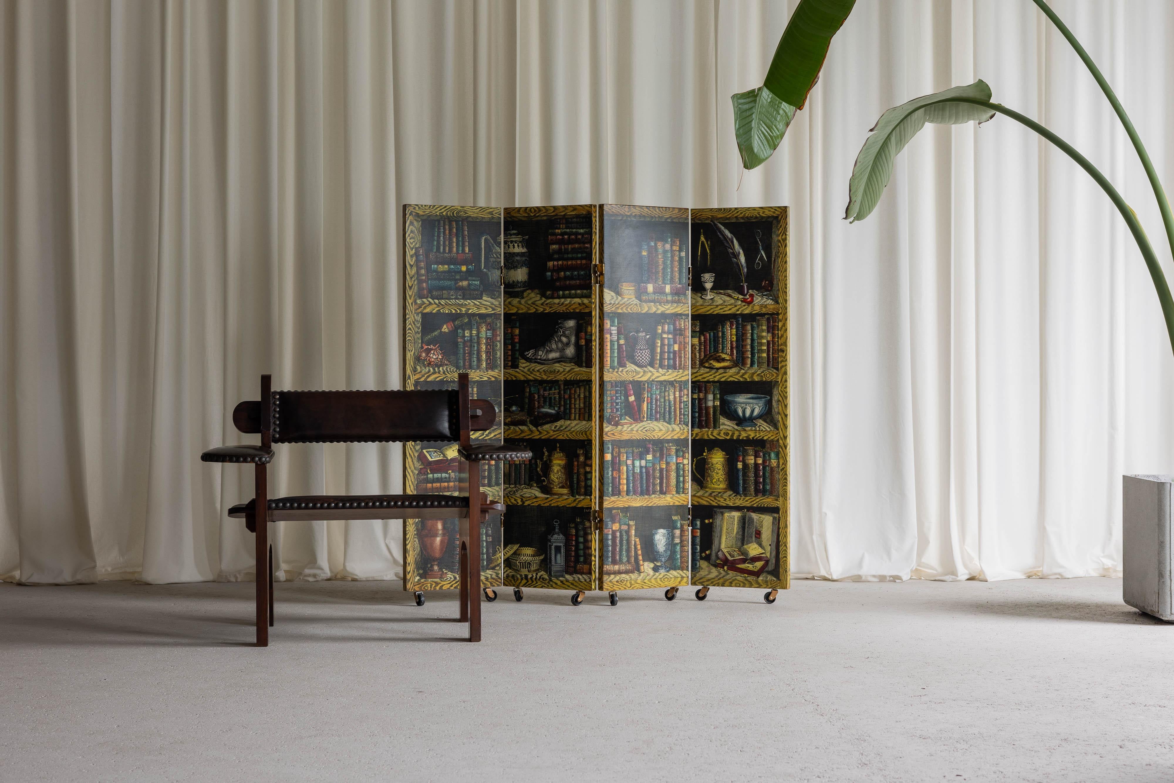 Rare early paraventi / foldable screen designed by Piero Fornasetti and manufactured by Fornasetti in Italy in 1954. This version consists a ‘Libri’ theme on one side and a 'Battaglia Navale’ theme on the other. Fornasetti had many artistic
