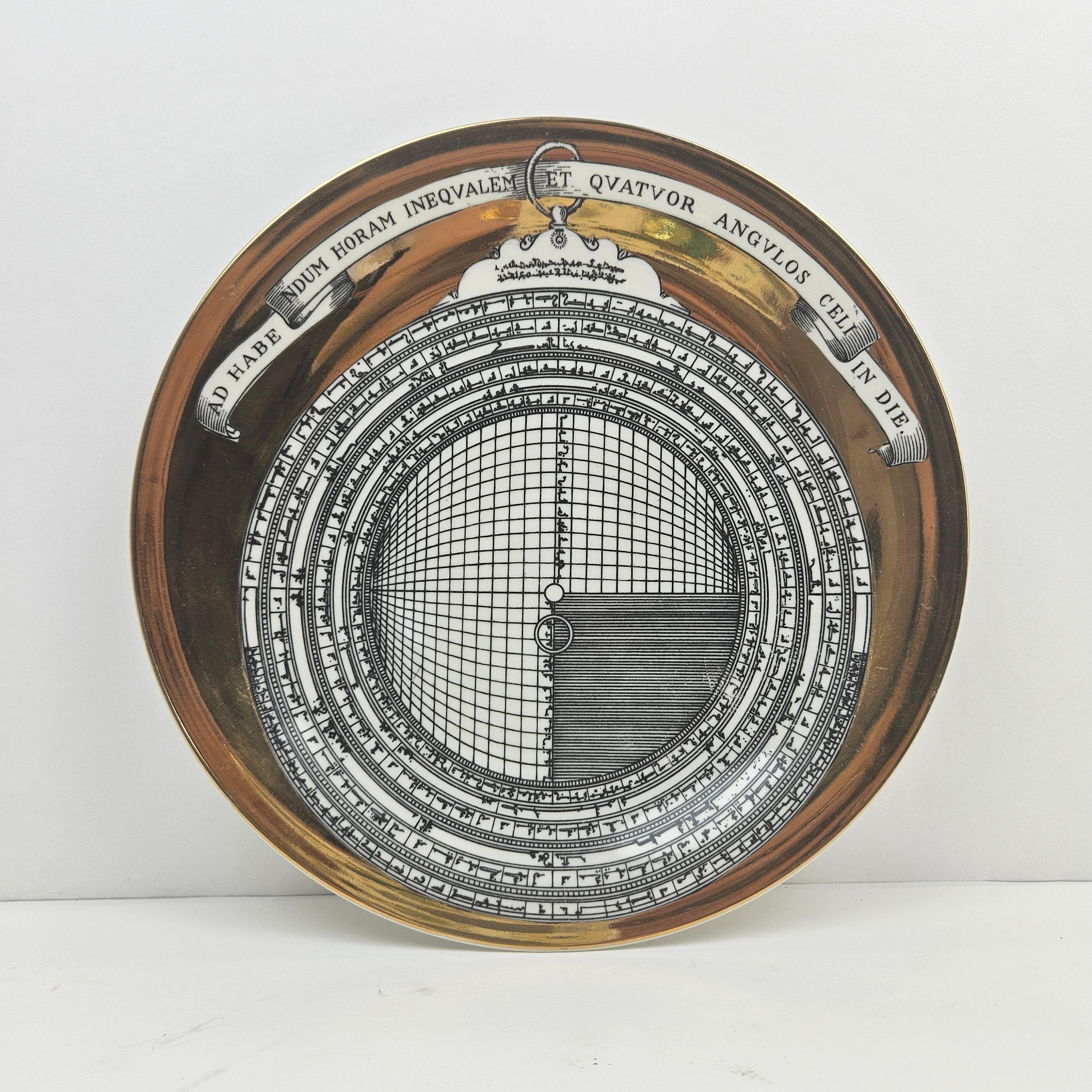 The Piero Fornasetti porcelain plate depicts an astrolabe, it is number five of twelve in series. 
This is a very rare edition with the special mark on the back side 